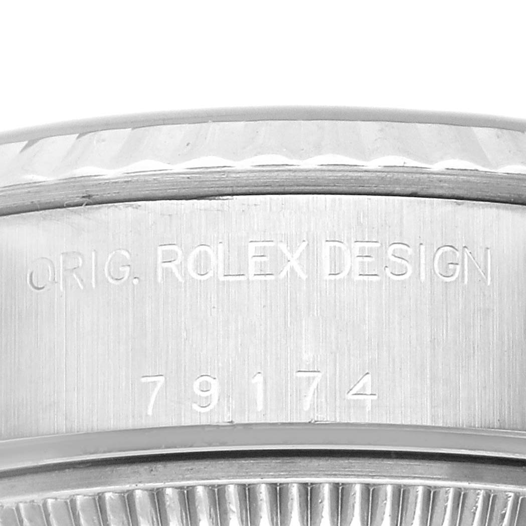 This image shows a close-up of a Rolex Datejust 79174 Women's Stainless Steel Black Dial 79174 Women's Stainless Steel Black Dial watch, focusing on the engraved side view of the case with the design and model number.