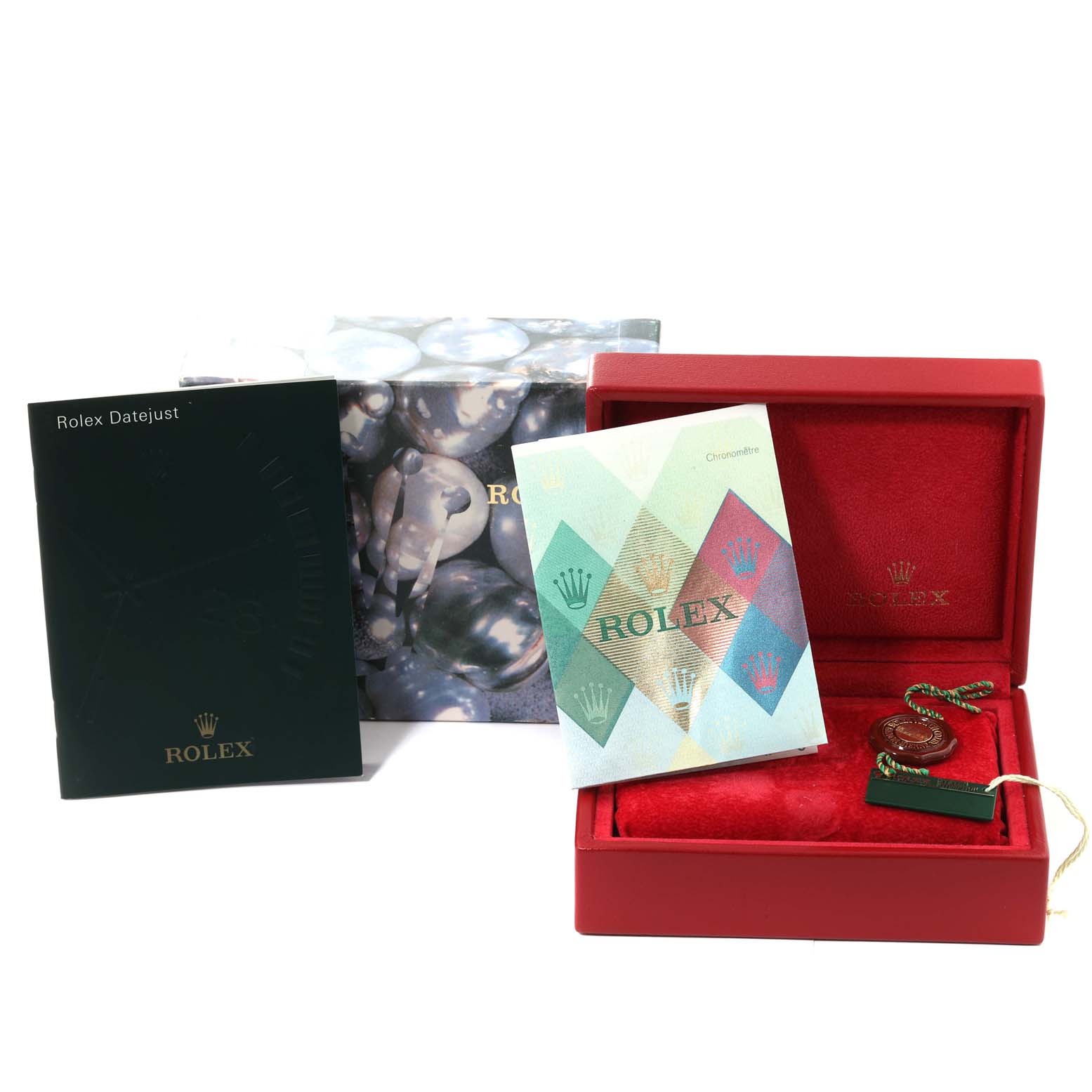 The image shows the accessories of a Rolex Datejust 79174 Women's Stainless Steel Black Dial 79174 Women's Stainless Steel Black Dial watch, including its box, booklets, and tags, from a frontal angle.