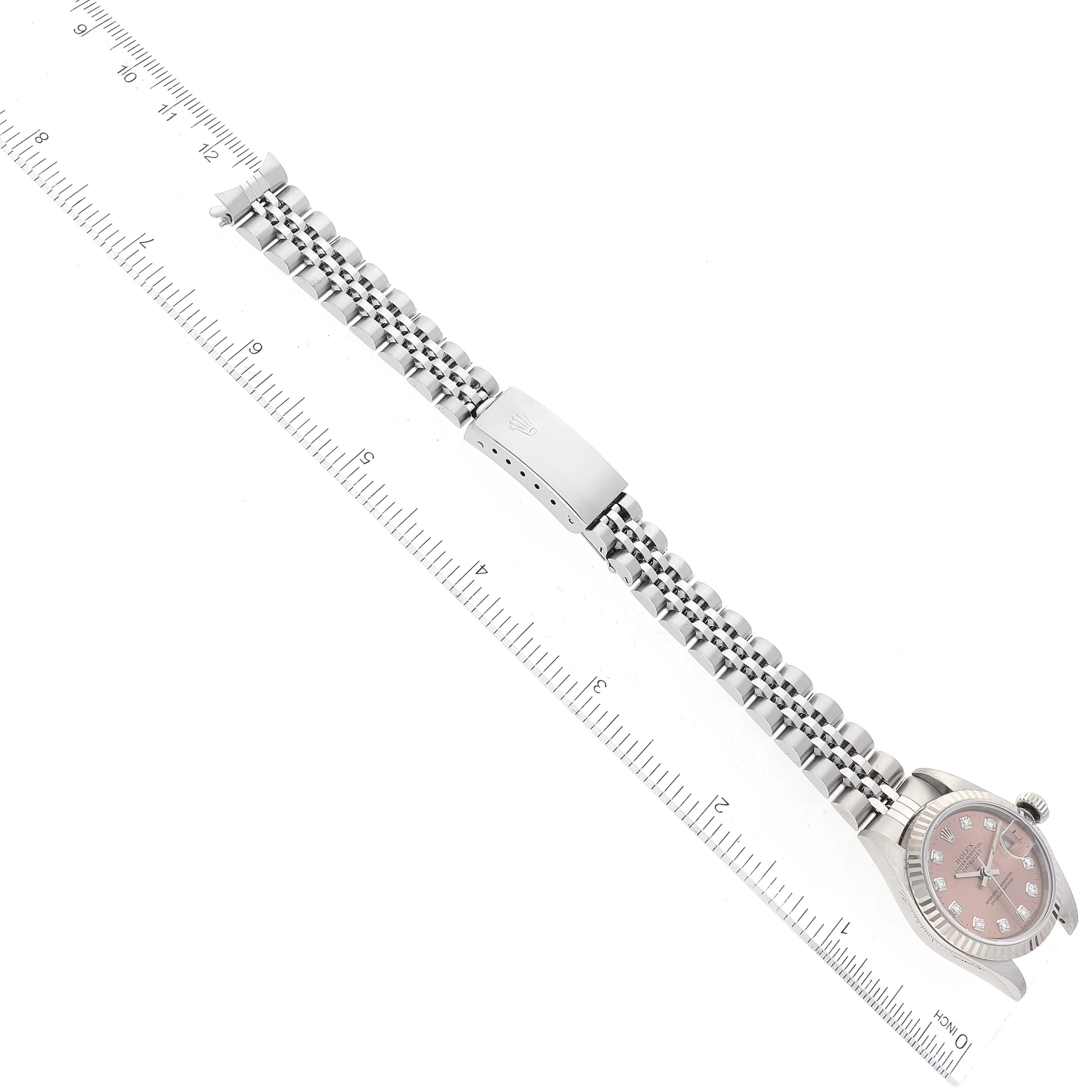 The image shows a side view of a Rolex Datejust 79174 Women's Stainless Steel Pink Dial 79174 Women's Stainless Steel Pink Dial watch and its bracelet, placed next to a ruler.