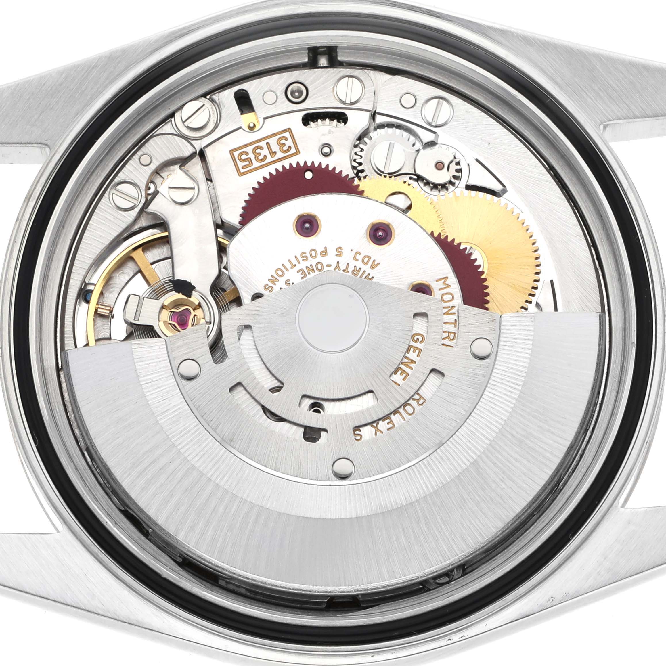 The image shows the movement of a Rolex Datejust model 16233 watch, viewed from the back, highlighting its intricate gears and components.