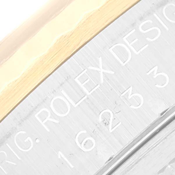 This is a close-up angle of the case back of a Rolex Datejust 16233 Men's Steel and Gold (two tone) White Dial 16233 Men's Steel and Gold (two tone) White Dial, showing the engraved text and part of the watch case.