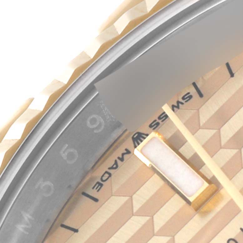 The image shows a close-up of the bezel, dial, and part of the hour hand of a Rolex Datejust 126233 Men
s Steel and Gold (two tone) Champagne Dial 126233 Men
s Steel and Gold (two tone) Champagne Dial watch.