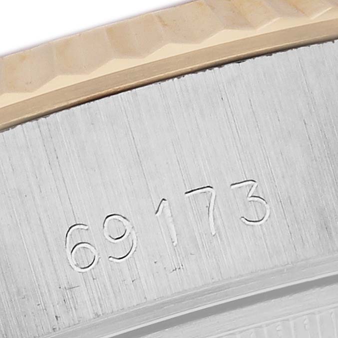This close-up shot of a Rolex Datejust 69173 Women's Steel and Gold (two tone) Champagne Dial 69173 Women's Steel and Gold (two tone) Champagne Dial watch focuses on the model number engraved on the case.