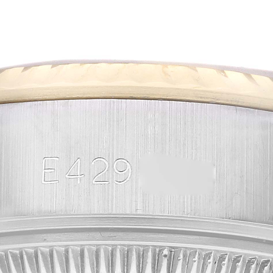 The image shows a close-up of the case side of the Rolex Datejust 69173 Women's Steel and Gold (two tone) Champagne Dial 69173 Women's Steel and Gold (two tone) Champagne Dial, highlighting the serial number engraving.