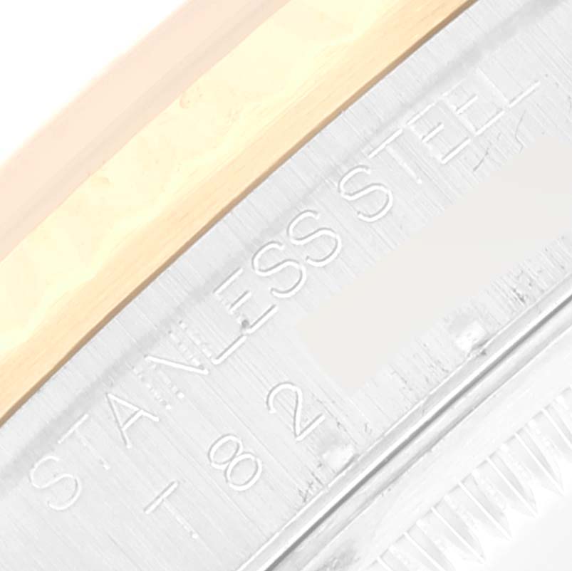 The image shows a close-up of the side of a Rolex Datejust 16233 Men's Steel and Gold (two tone) White Dial 16233 Men's Steel and Gold (two tone) White Dial watch, highlighting the stainless steel and some engravings.