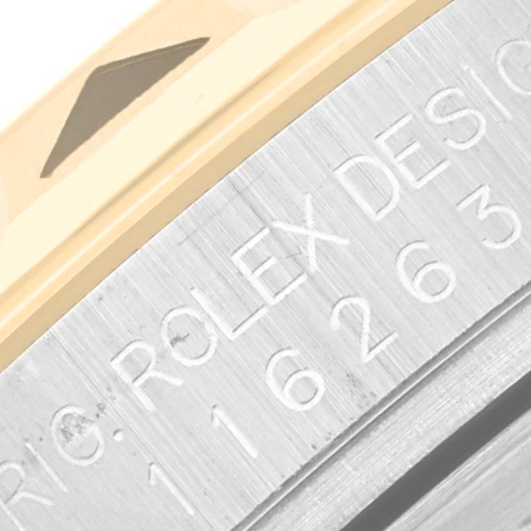 Close-up of the edge of the bezel and the engraved side of the case of a Rolex Turn-o-Graph 116263 Men
s Steel and Gold (two tone) White Dial 116263 Men
s Steel and Gold (two tone) White Dial watch.