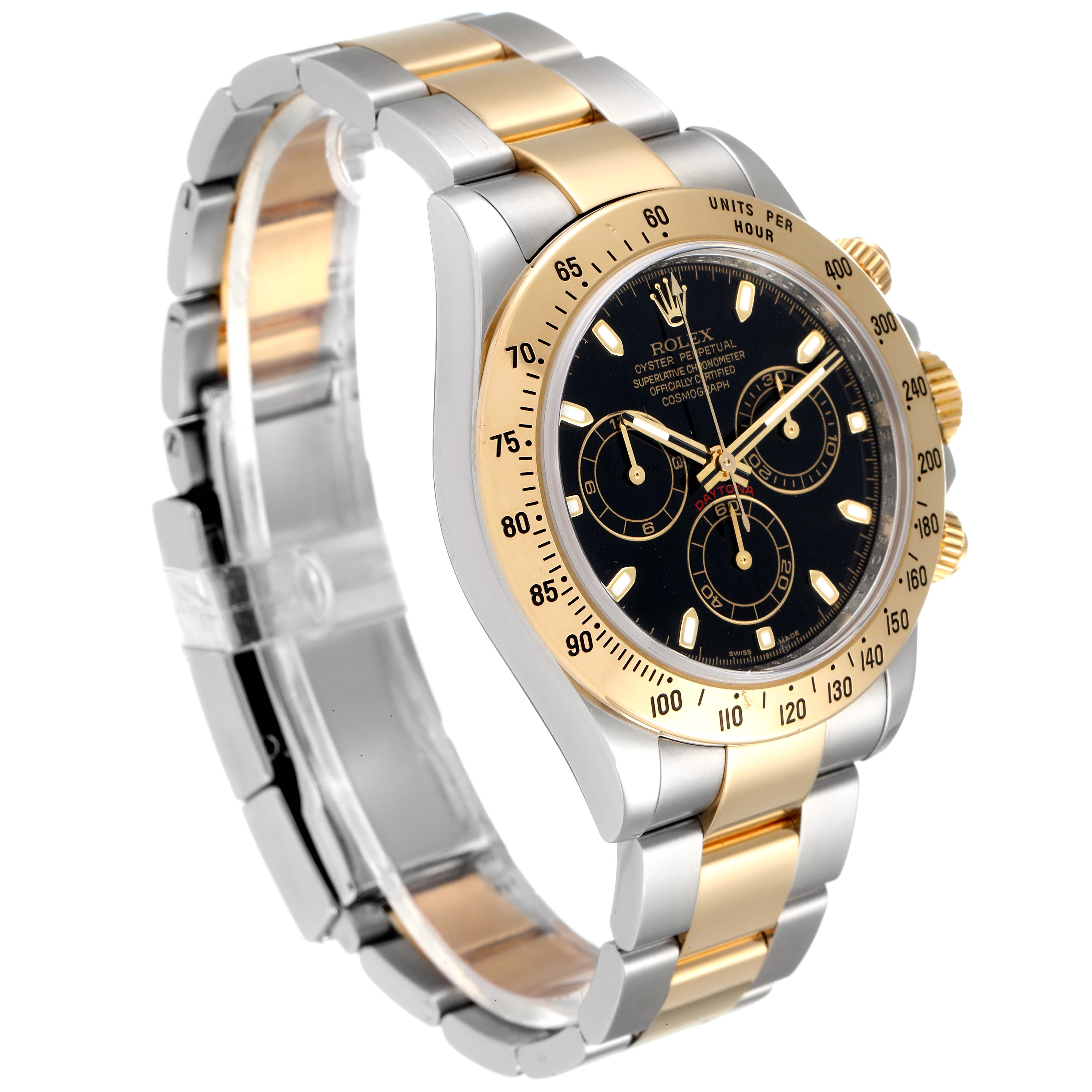 The image shows a Rolex Daytona 116523 Men
s Steel and Gold (two tone) Black Dial 116523 Men
s Steel and Gold (two tone) Black Dial watch at an angled view, highlighting its gold and silver bracelet, bezel, and black dial with three subdials.