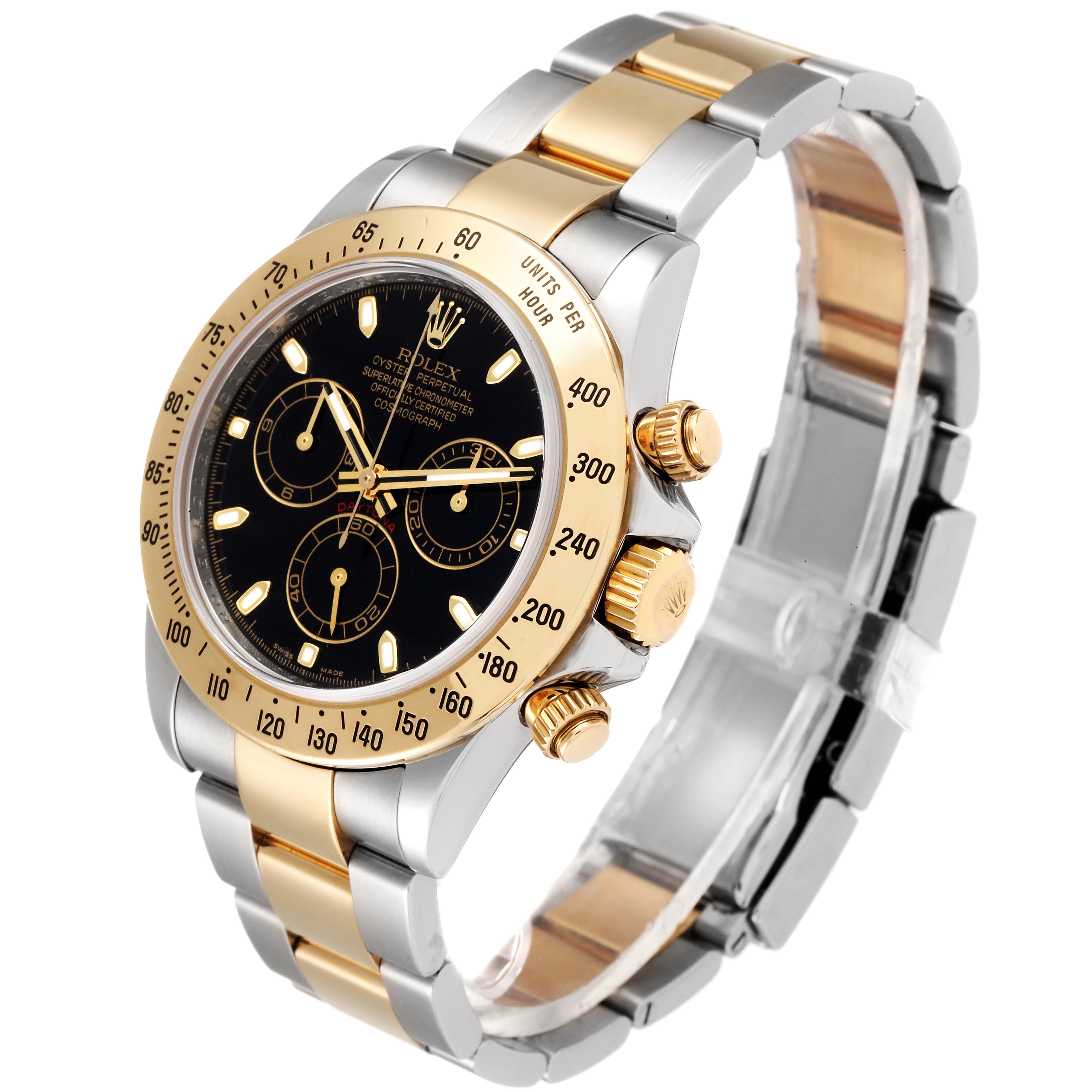 This image shows a Rolex Daytona 116523 Men
s Steel and Gold (two tone) Black Dial 116523 Men
s Steel and Gold (two tone) Black Dial watch angled to display the face, bezel, crown, pushers, and two-tone bracelet.