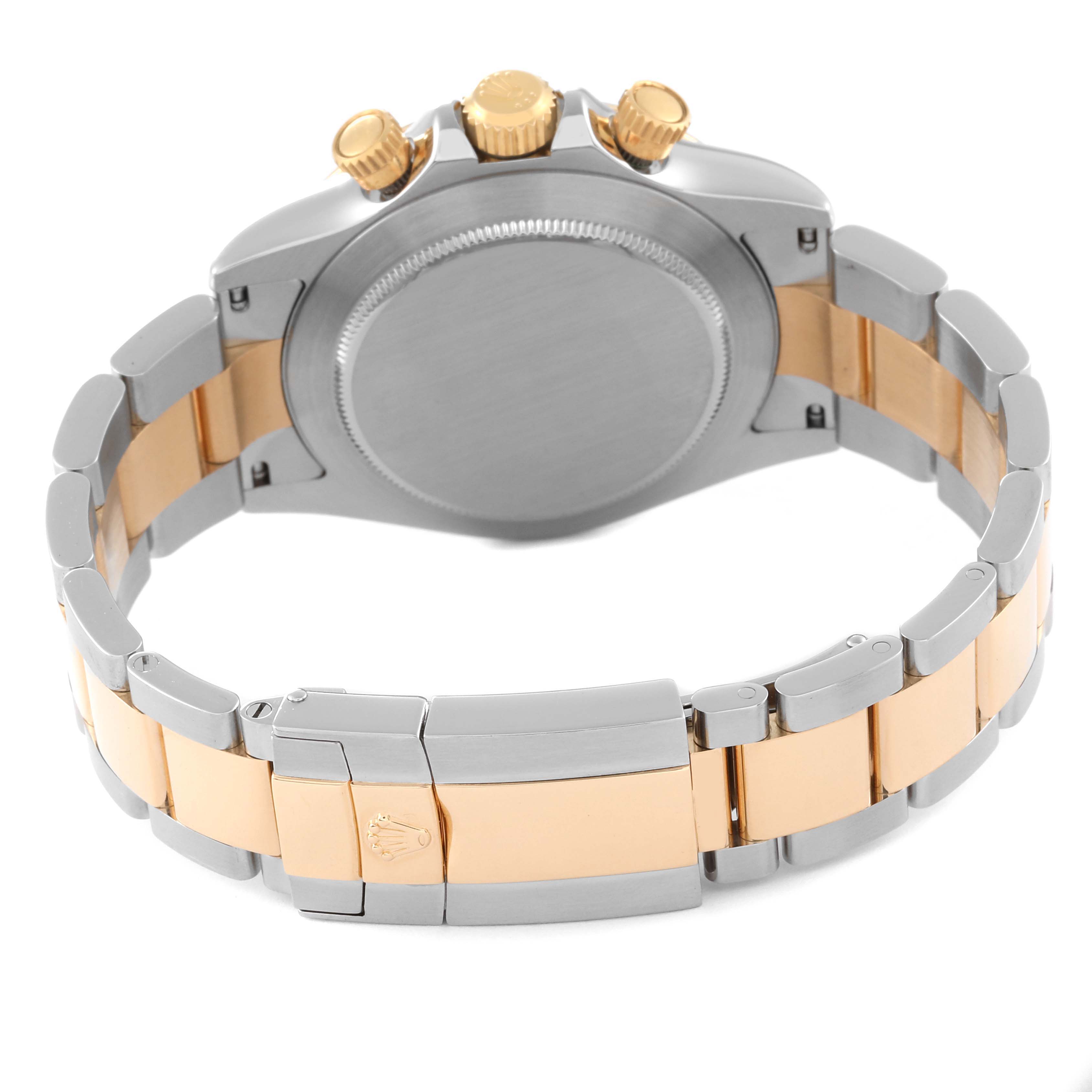 The image shows the back case and bracelet clasp of a Rolex Daytona 116523 Men's Steel and Gold (two tone) Black Dial 116523 Men's Steel and Gold (two tone) Black Dial watch, featuring a two-tone metal design.