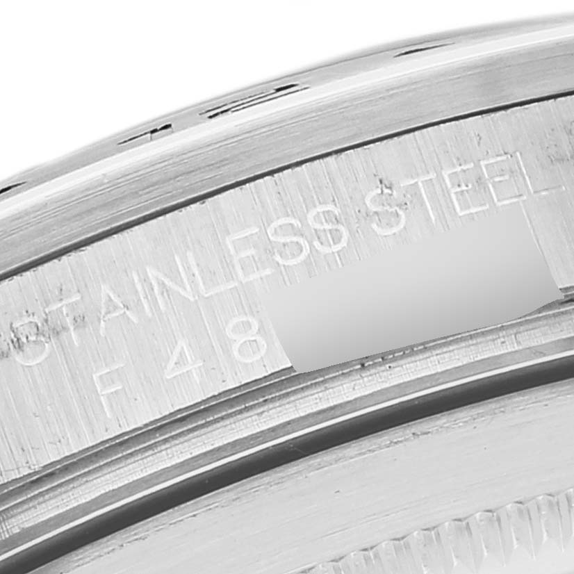 This close-up image shows part of the stainless steel outer edge, including the inscription, of a Rolex Explorer 16570 Men's Stainless Steel White Dial 16570 Men's Stainless Steel White Dial watch.