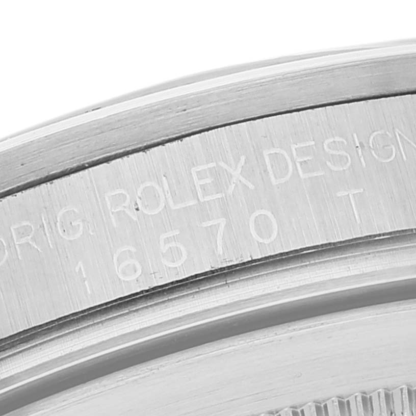 This image shows a close-up of the case side of a Rolex Explorer 16570 Men's Stainless Steel White Dial 16570 Men's Stainless Steel White Dial model 16570, focusing on its engraved serial number.