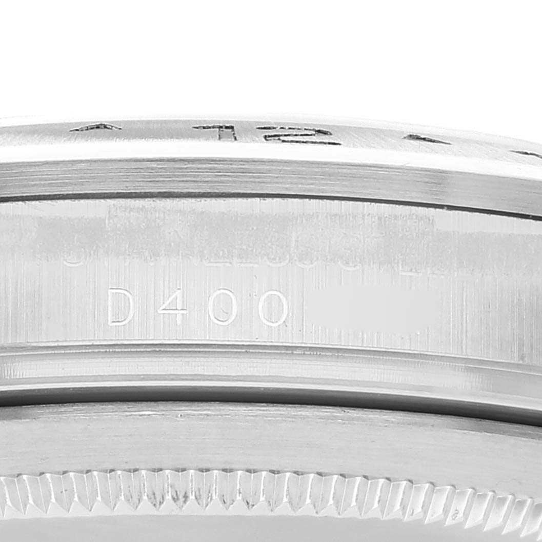 The image shows a close-up of the side of the case and bezel of a Rolex Explorer 16570 Men
s Stainless Steel Black Dial 16570 Men
s Stainless Steel Black Dial model, including serial number "D400."
