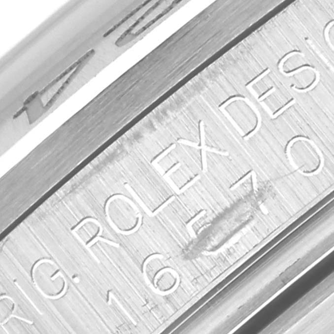 The image shows a close-up view of the engraved text on the side of the case of a Rolex Explorer 16570 Men
s Stainless Steel Black Dial 16570 Men
s Stainless Steel Black Dial watch.