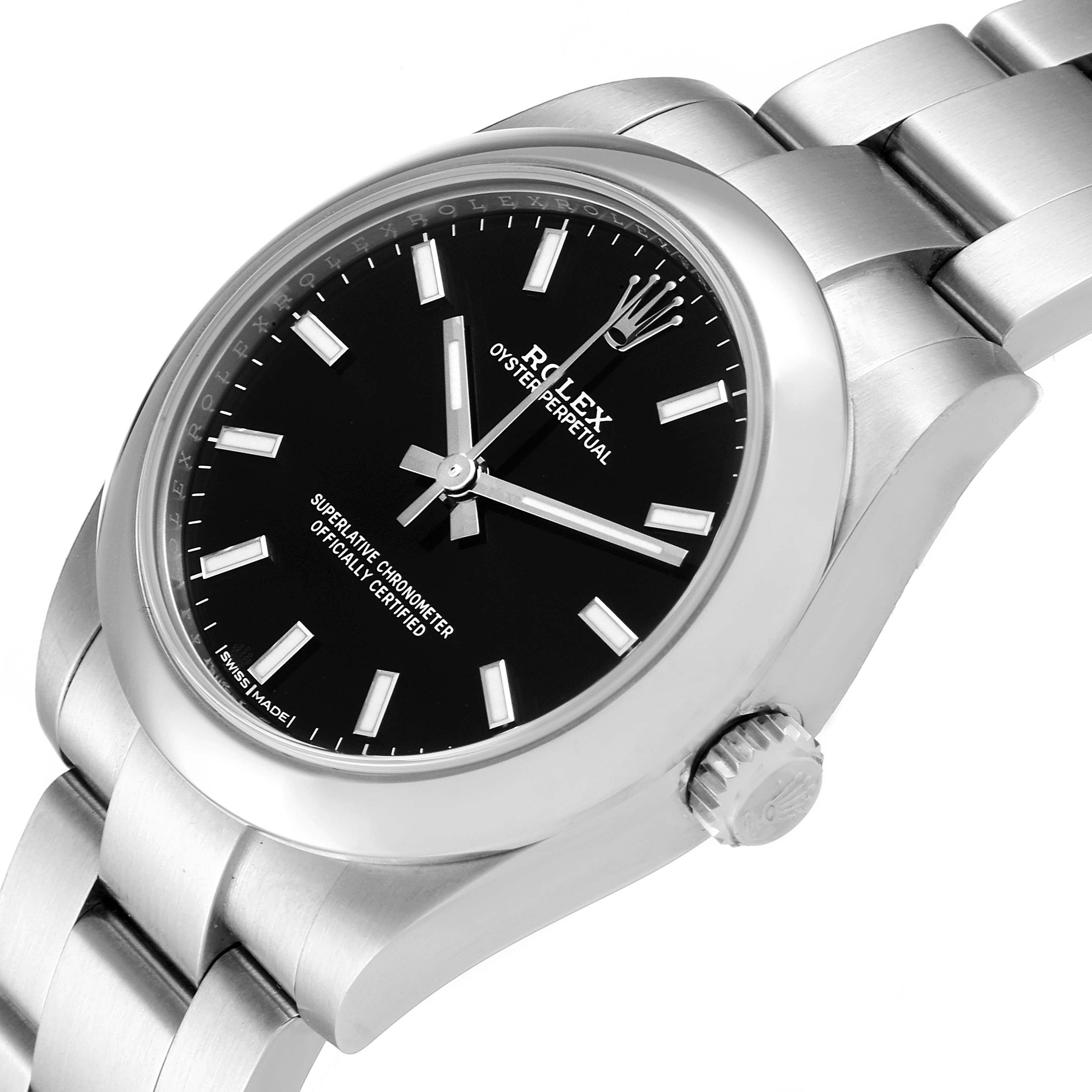 The image shows a Rolex Oyster Perpetual Mid-Size watch at an angled close-up, highlighting its black dial, case, and bracelet.