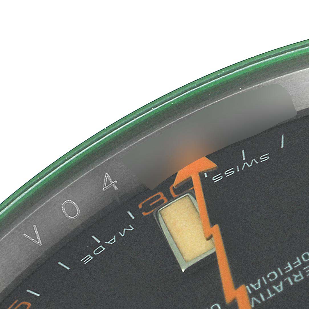 The image shows a close-up of the dial and edge of the bezel of a Rolex Milgauss 116400GV Men
s Stainless Steel Black Dial 116400GV Men
s Stainless Steel Black Dial watch, highlighting the orange lightning bolt-shaped seconds hand.