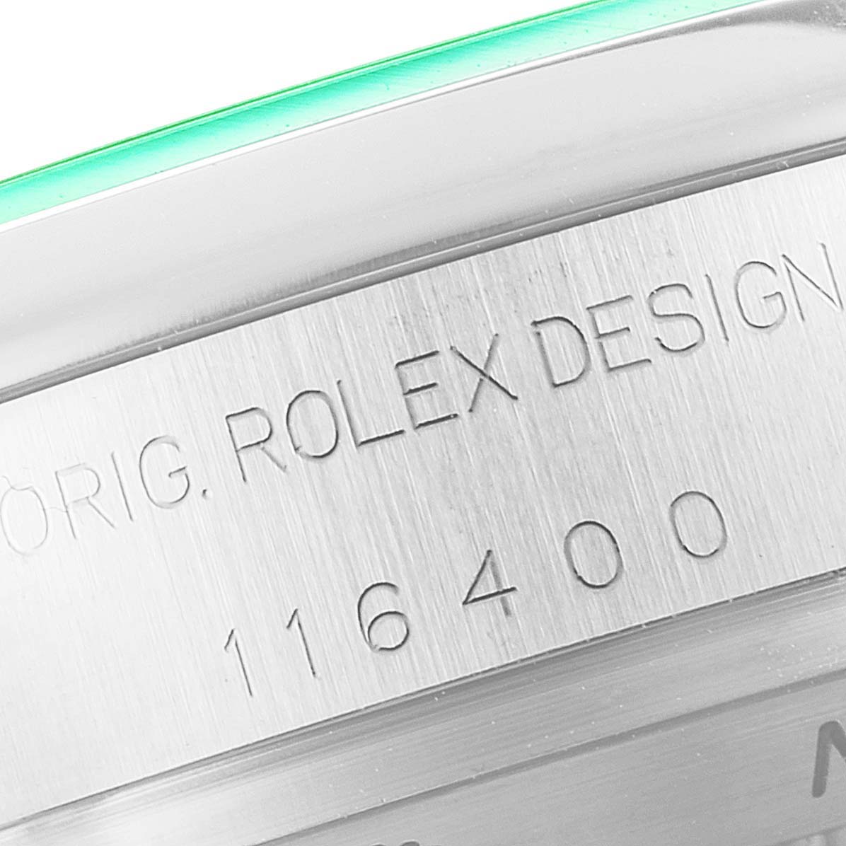 The image shows a close-up of the case side of a Rolex Milgauss 116400GV Men's Stainless Steel Blue Dial 116400GV Men's Stainless Steel Blue Dial, featuring the engraving "ORIG. ROLEX DESIGN 116400."
