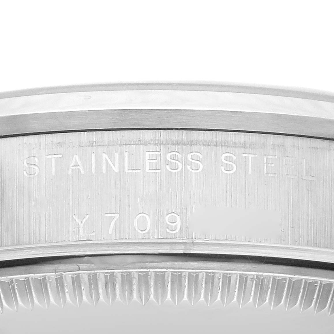 This image shows a close-up of the etched stainless steel back of a Mid-Size Rolex watch case.
