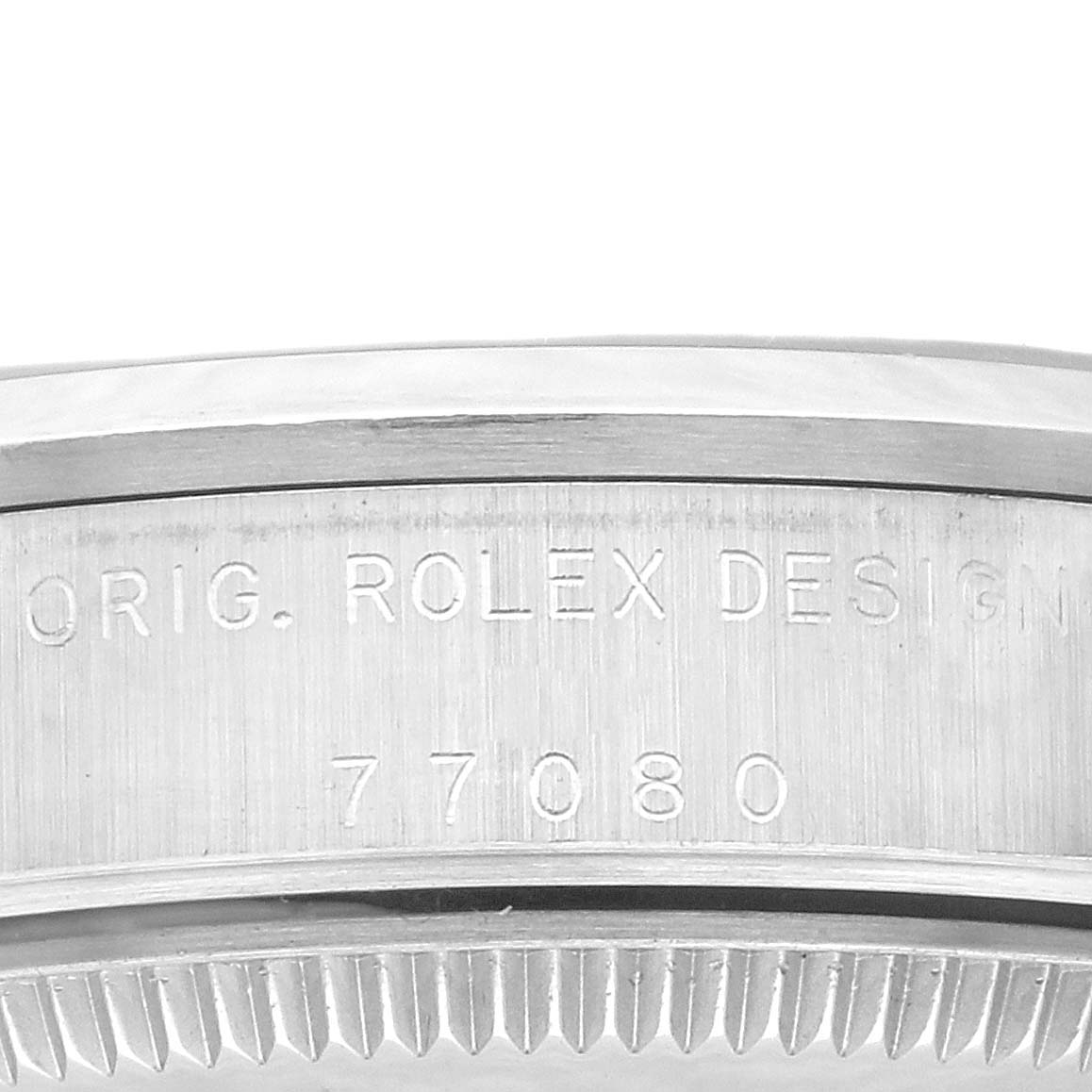 This image shows the side view of the case back edge of a Rolex Mid-Size 77080 Women's Stainless Steel Pink Dial 77080 Women's Stainless Steel Pink Dial model, featuring engraved text and the model number.