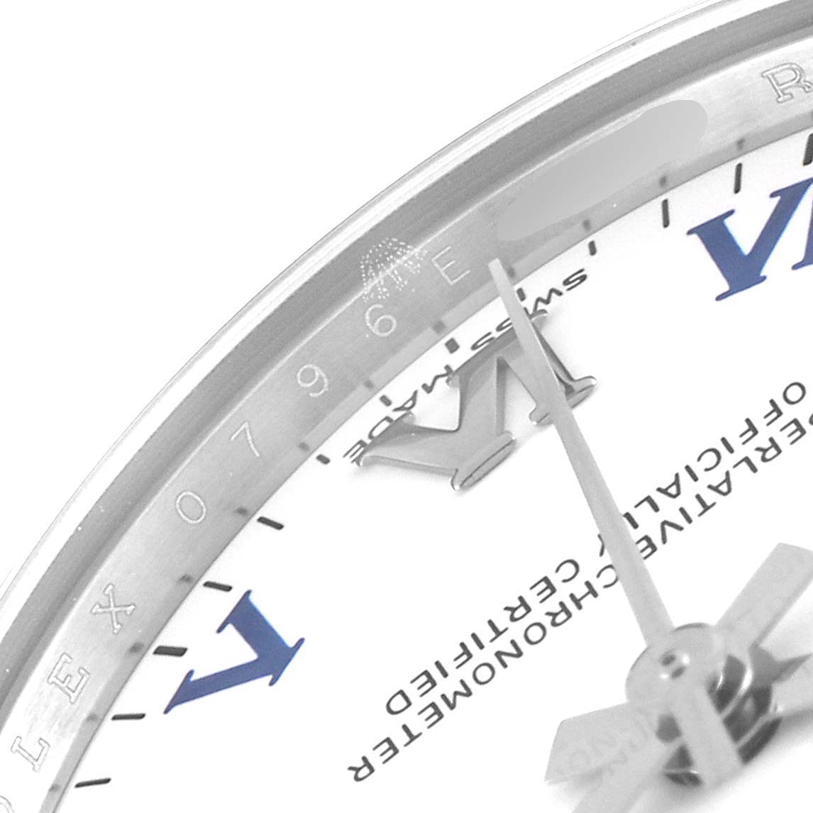 This close-up angle of the Rolex Mid-Size 177200 Women's Stainless Steel White Dial 177200 Women's Stainless Steel White Dial model watch shows the edge of the dial, hands, and part of the chapter ring.