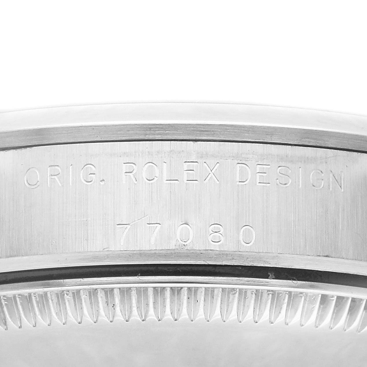 Close-up of the side view of the bezel of a Mid-Size Rolex watch, showing "ORIG. ROLEX DESIGN" and the model number "77080."