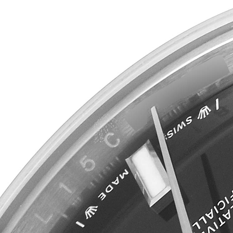 This close-up image of the Rolex Oyster Perpetual 276200 Women's Stainless Steel Black Dial 276200 Women's Stainless Steel Black Dial watch shows part of the dial, minute markers, and the hour hand.