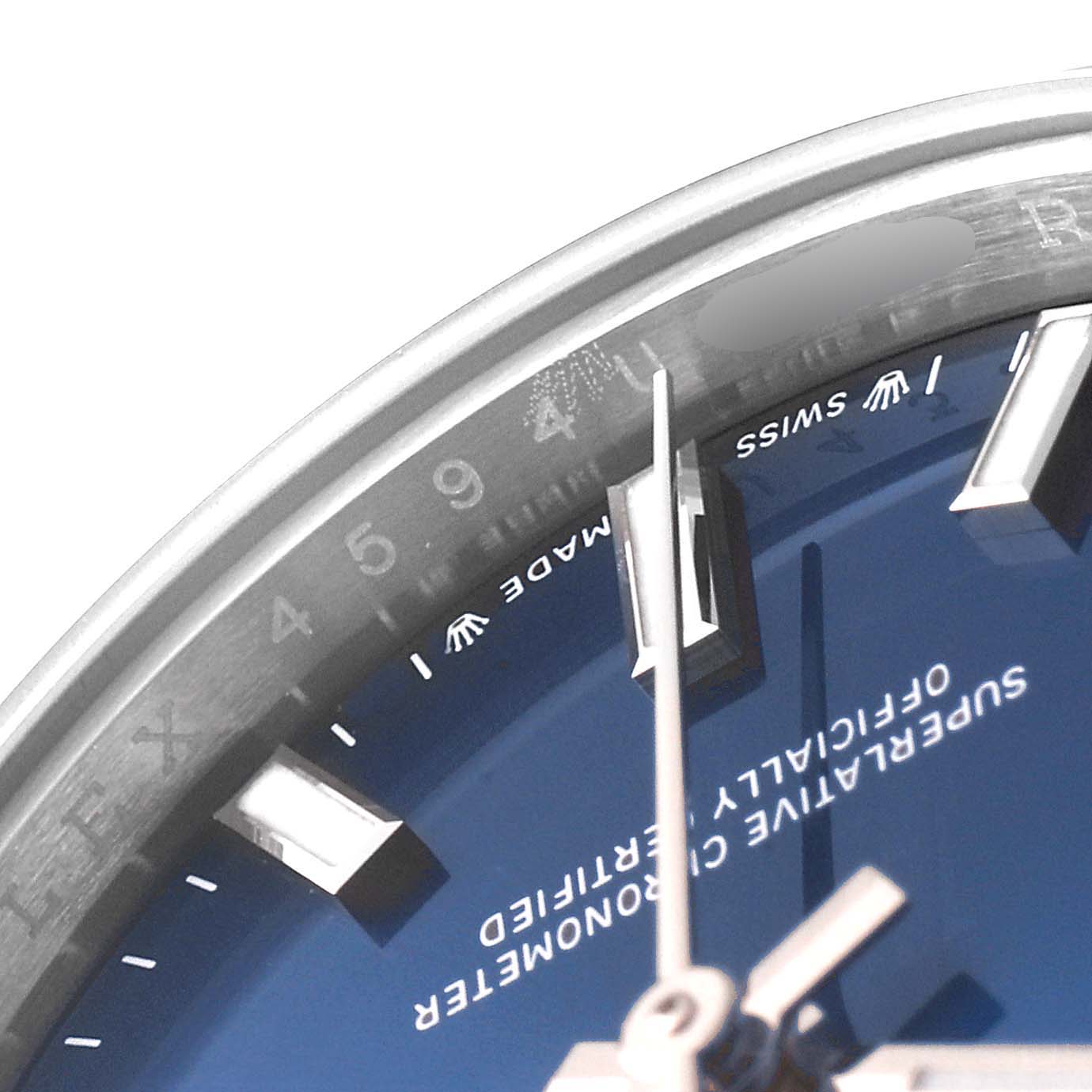 This image shows a close-up of the Rolex Oyster Perpetual 276200 Women
s Stainless Steel Blue Dial 276200 Women
s Stainless Steel Blue Dial watch
s dial, hands, indexes, and part of the inner bezel at an angled view.