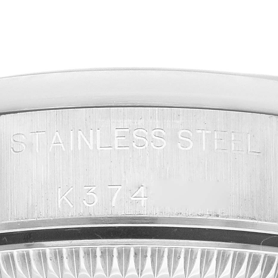 This image shows a close-up of the case back edge of a Rolex Oyster Perpetual 76080 Women's Stainless Steel Black Dial 76080 Women's Stainless Steel Black Dial watch, specifically highlighting the stainless steel marking.