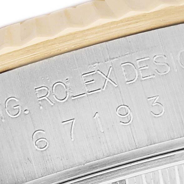 This close-up shows part of the case back and engraving details of a Rolex Oyster Perpetual 67193 Women
s Steel and Gold (two tone) White Dial 67193 Women
s Steel and Gold (two tone) White Dial watch.