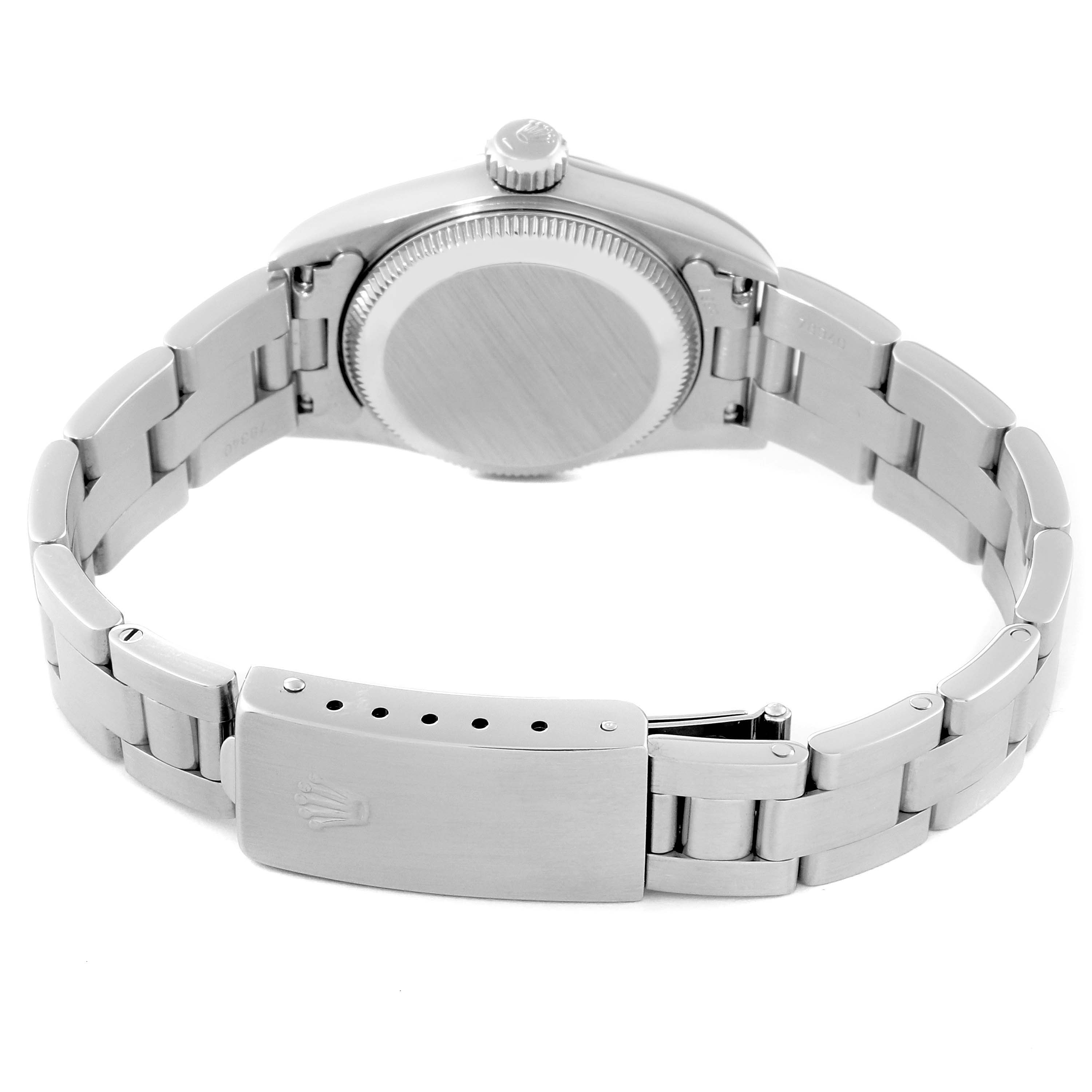 The image shows the back view of a Rolex Oyster Perpetual 67230 Women's Stainless Steel White Dial 67230 Women's Stainless Steel White Dial watch, highlighting the case back and the clasp of the metal bracelet.