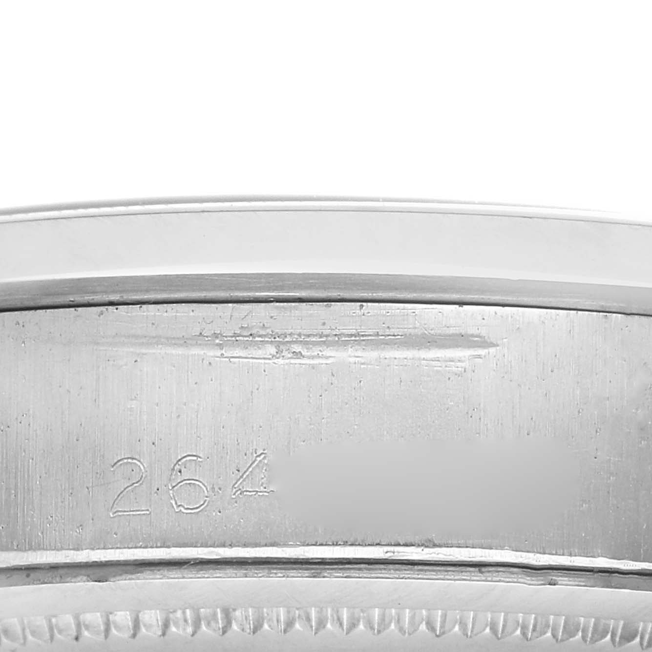 The image shows a close-up side view of the case edge with a numerical engraving on a Rolex Vintage Collection model, number 6694.