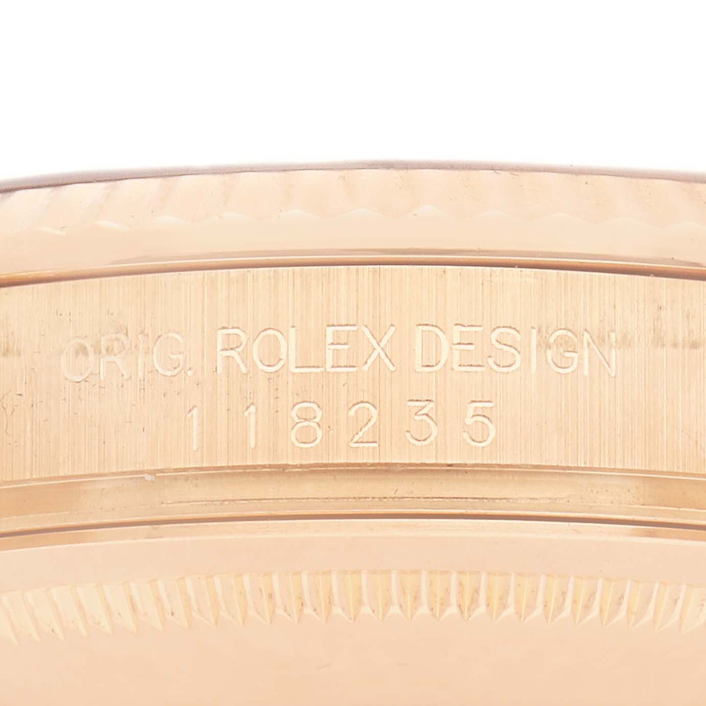 The image shows the side of a Rolex President model, number 118235, featuring the engraved design and model details on the case's edge.