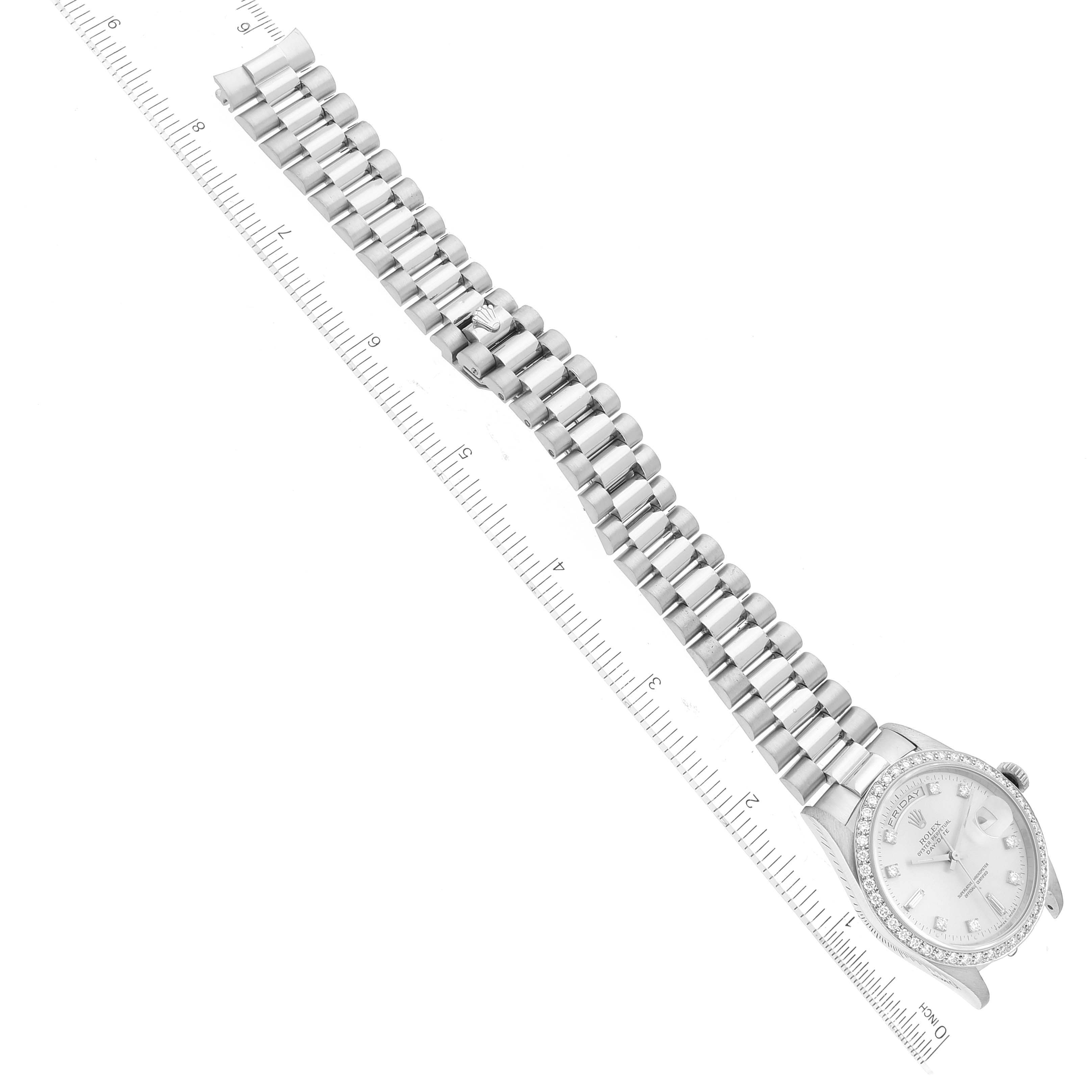 The image shows a top-down view of a Rolex President 18346 Men's Platinum Silver Dial 18346 Men's Platinum Silver Dial model watch, displaying its dial and bracelet laid next to a ruler.
