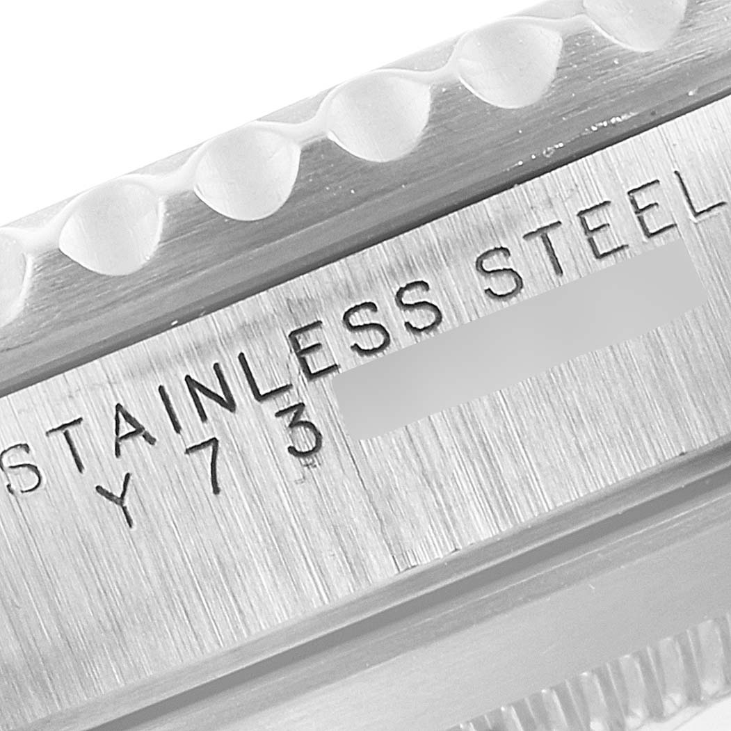 Close-up of the side of a Rolex Submariner 14060M Men
s Stainless Steel Black Dial 14060M Men
s Stainless Steel Black Dial
s case showing the "STAINLESS STEEL" engraving.