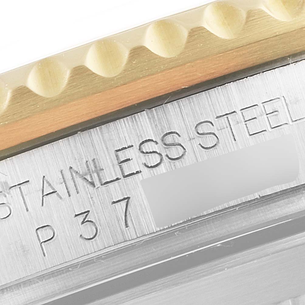 The image shows a close-up of the bezel and engraved stainless steel case of a Rolex Submariner 16613 Men
s Steel and Gold (two tone) Blue Dial 16613 Men
s Steel and Gold (two tone) Blue Dial watch.