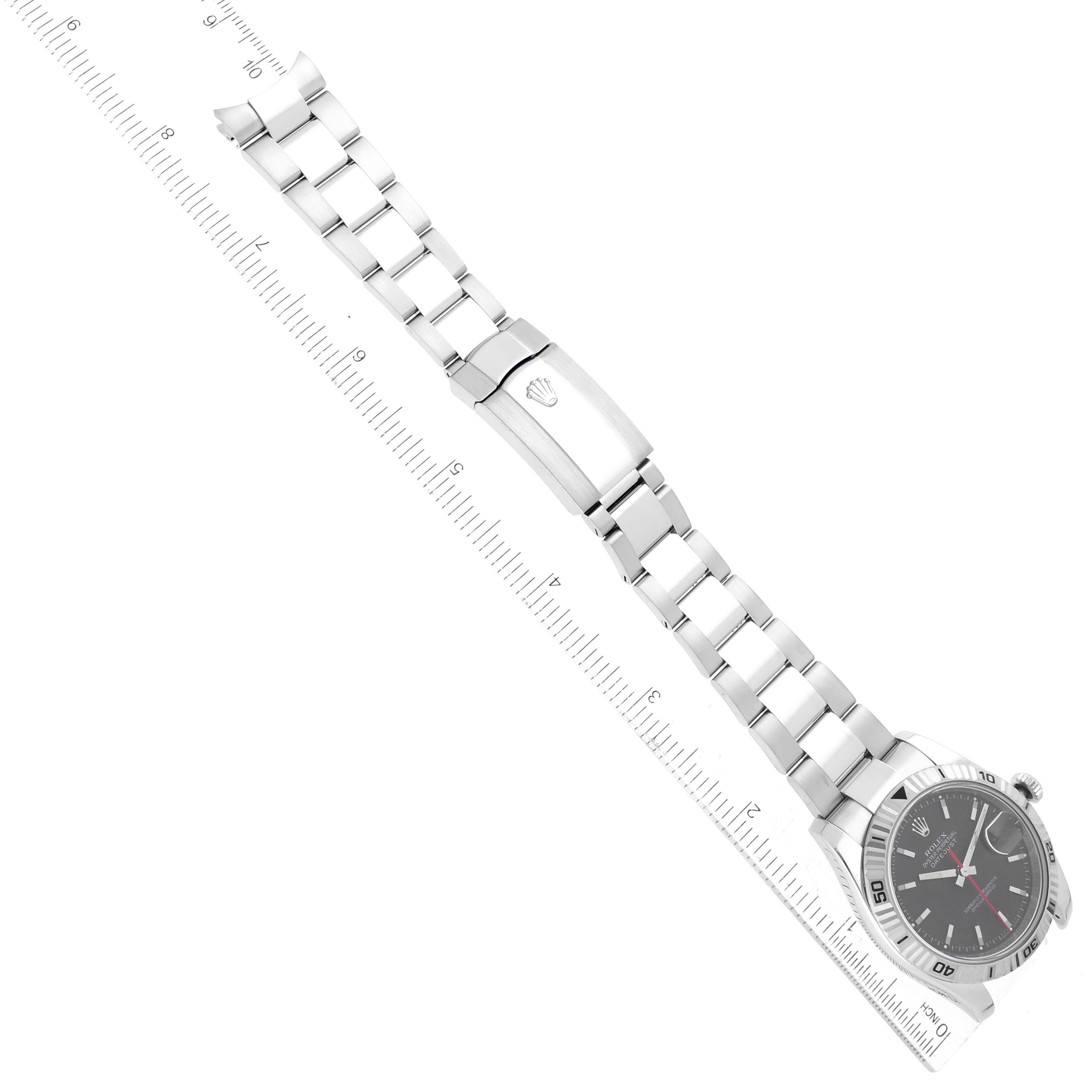 This image shows the Rolex Turn-o-Graph 116264 Men's Stainless Steel Black Dial 116264 Men's Stainless Steel Black Dial watch laid flat, highlighting the face, bezel, and the bracelet with a ruler for scale.