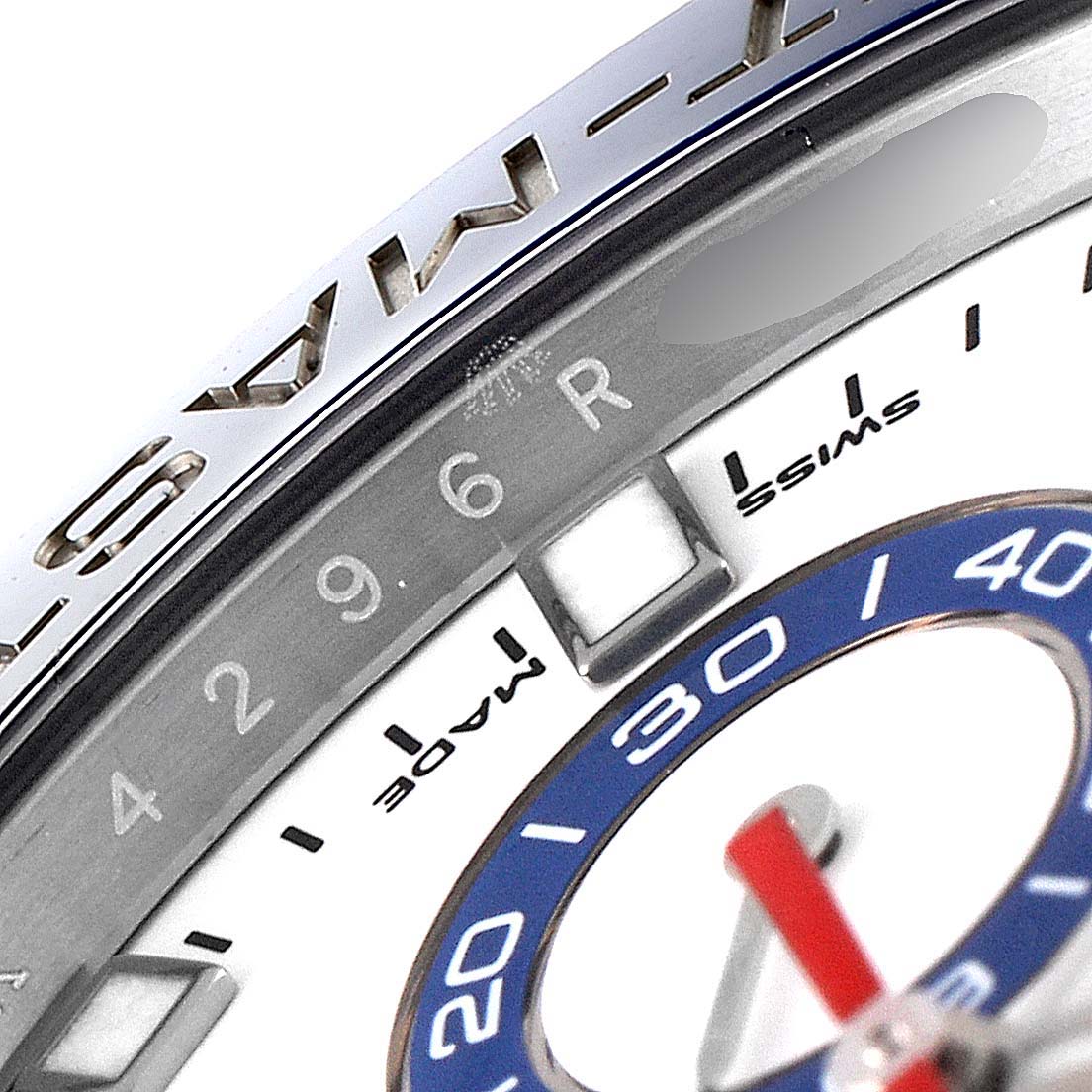 This close-up image of the Rolex Yacht-Master 116680 Men's Stainless Steel White Dial 116680 Men's Stainless Steel White Dial watch shows part of the bezel, the minute markers, and part of the dial.