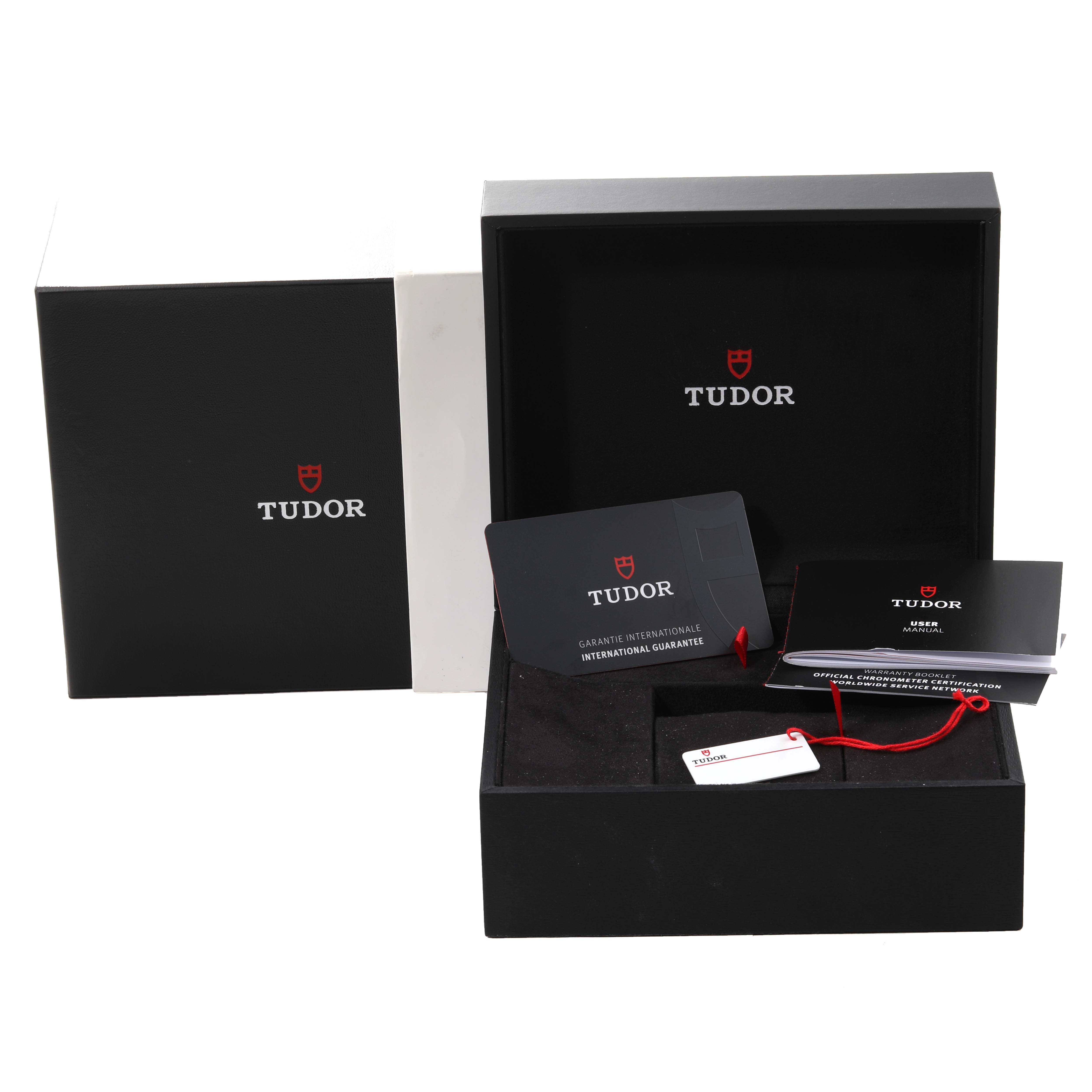 The image shows the packaging and accessories for the Tudor Heritage Black Bay M79470-0003 Men
s Stainless Steel Black Dial M79470-0003 Men
s Stainless Steel Black Dial watch, including the box, guarantee card, and manuals.