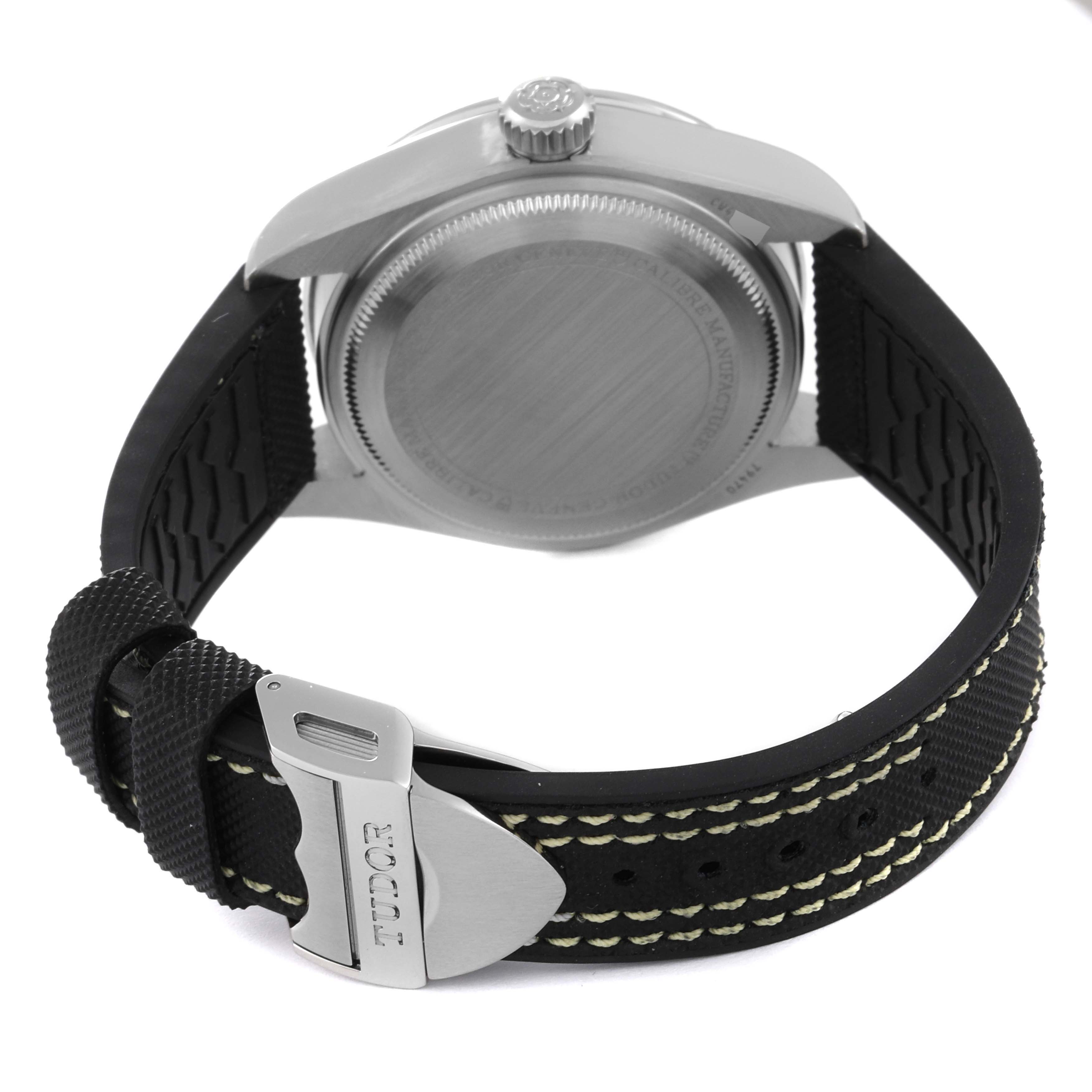 The image shows the back view of a Tudor Heritage Black Bay M79470-0003 Men
s Stainless Steel Black Dial M79470-0003 Men
s Stainless Steel Black Dial watch, highlighting its case back, crown, and strap with the Tudor logo on the clasp.