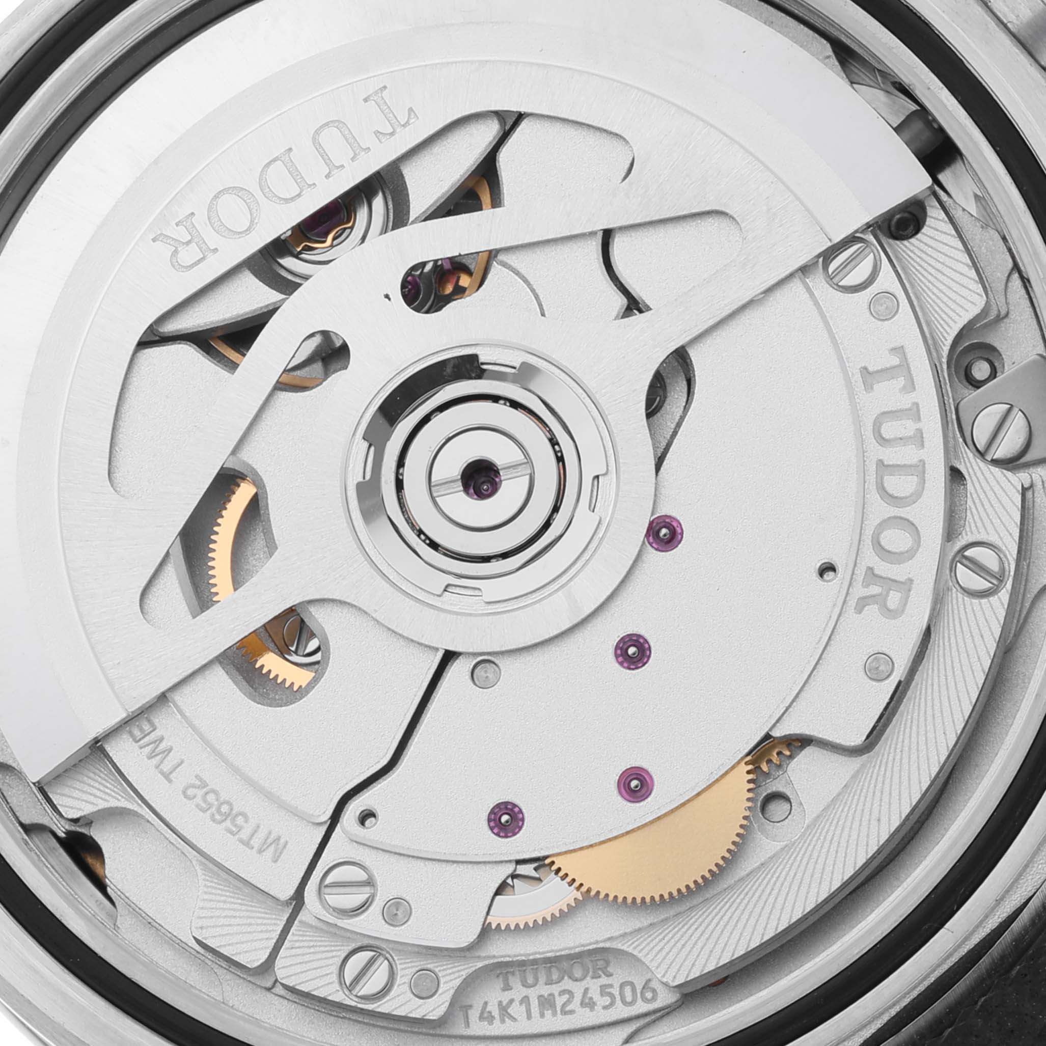 This image shows a close-up of the Heritage Black Bay
s internal mechanism by Tudor, revealing its components and engravings.
