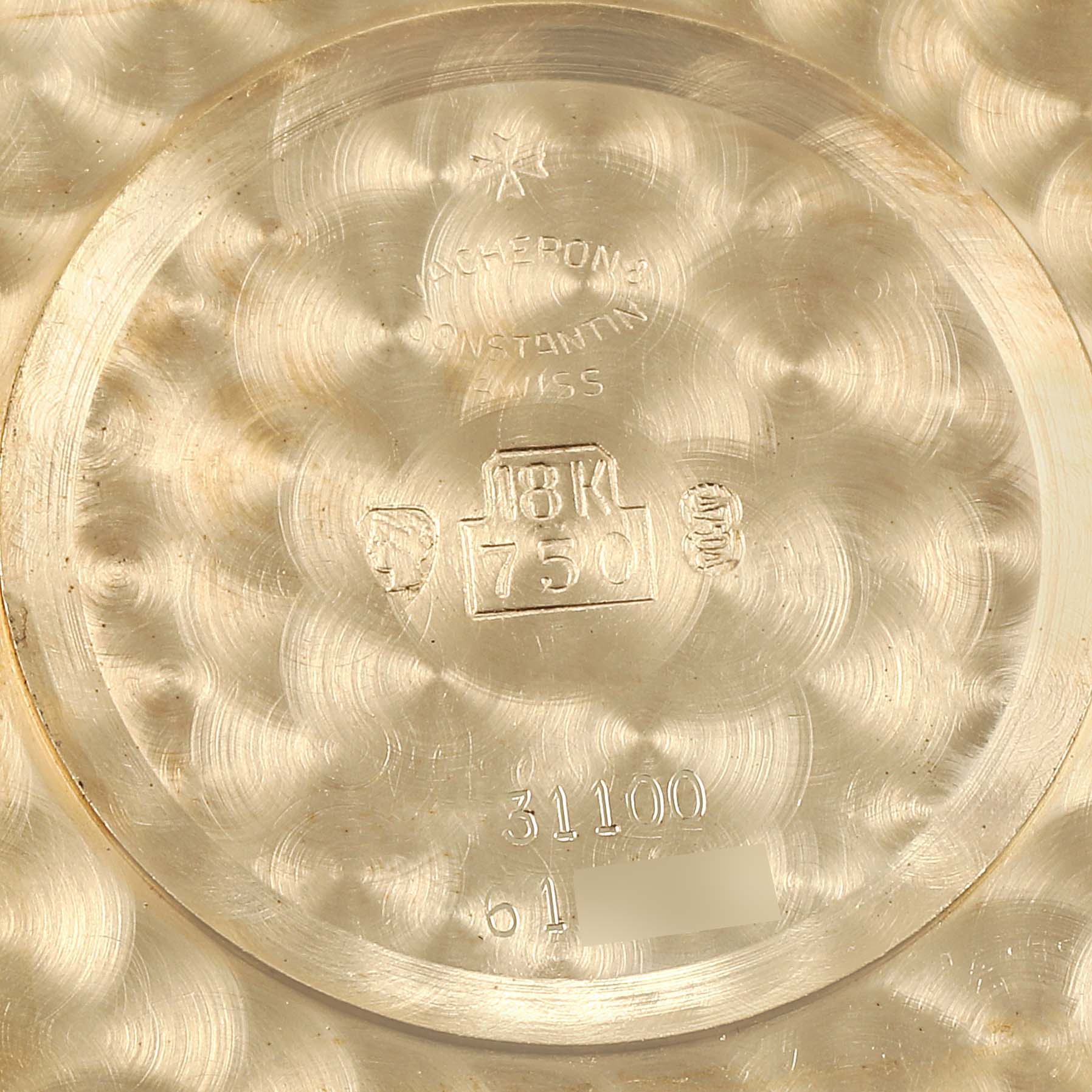 This image shows the inner caseback of a vintage Vacheron Constantin watch, featuring hallmarks and inscriptions.