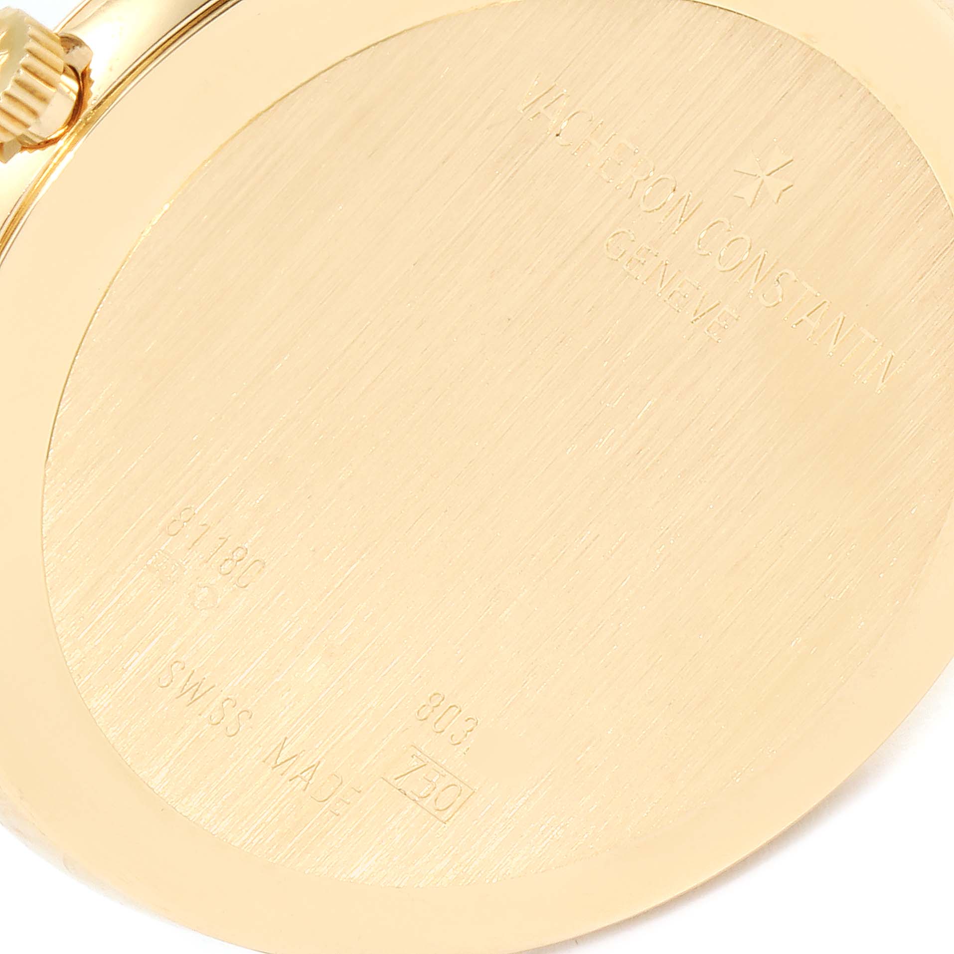 This image shows the back case and crown of a Vacheron Constantin Patrimony 81180 Men's Yellow Gold Silver Dial 81180 Men's Yellow Gold Silver Dial watch at an angle.