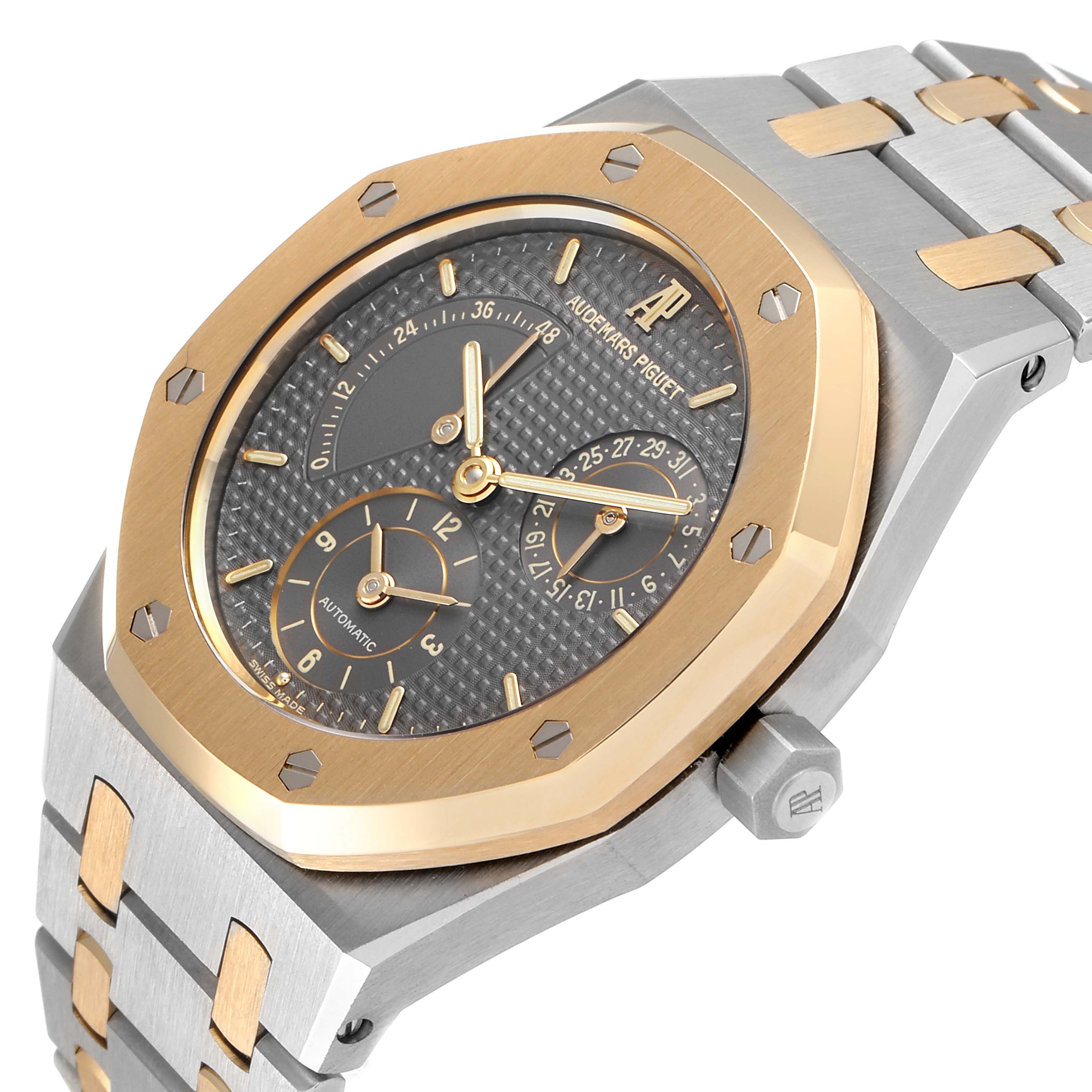 The image shows a close-up angle of an Audemars Piguet Royal Oak 25730SA.01.078 Men
s Steel and Gold (two tone) Silver Dial 25730SA.01.078 Men
s Steel and Gold (two tone) Silver Dial watch showcasing its dial, bezel, and part of the bracelet.