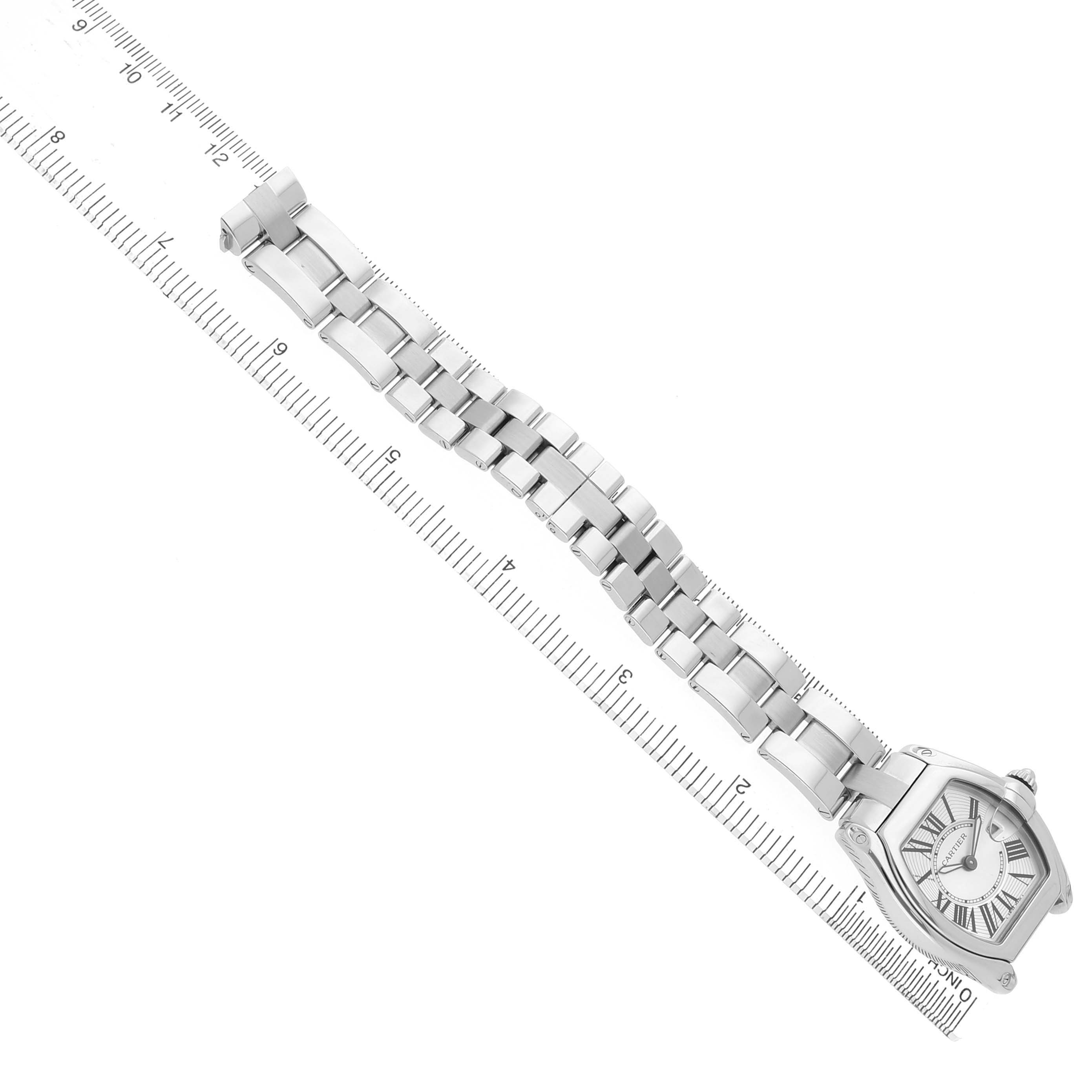 The Cartier Roadster W62016V3 Women's Stainless Steel Silver Dial watch is shown from a top-down angle, displaying the full bracelet alongside a ruler for measurement.