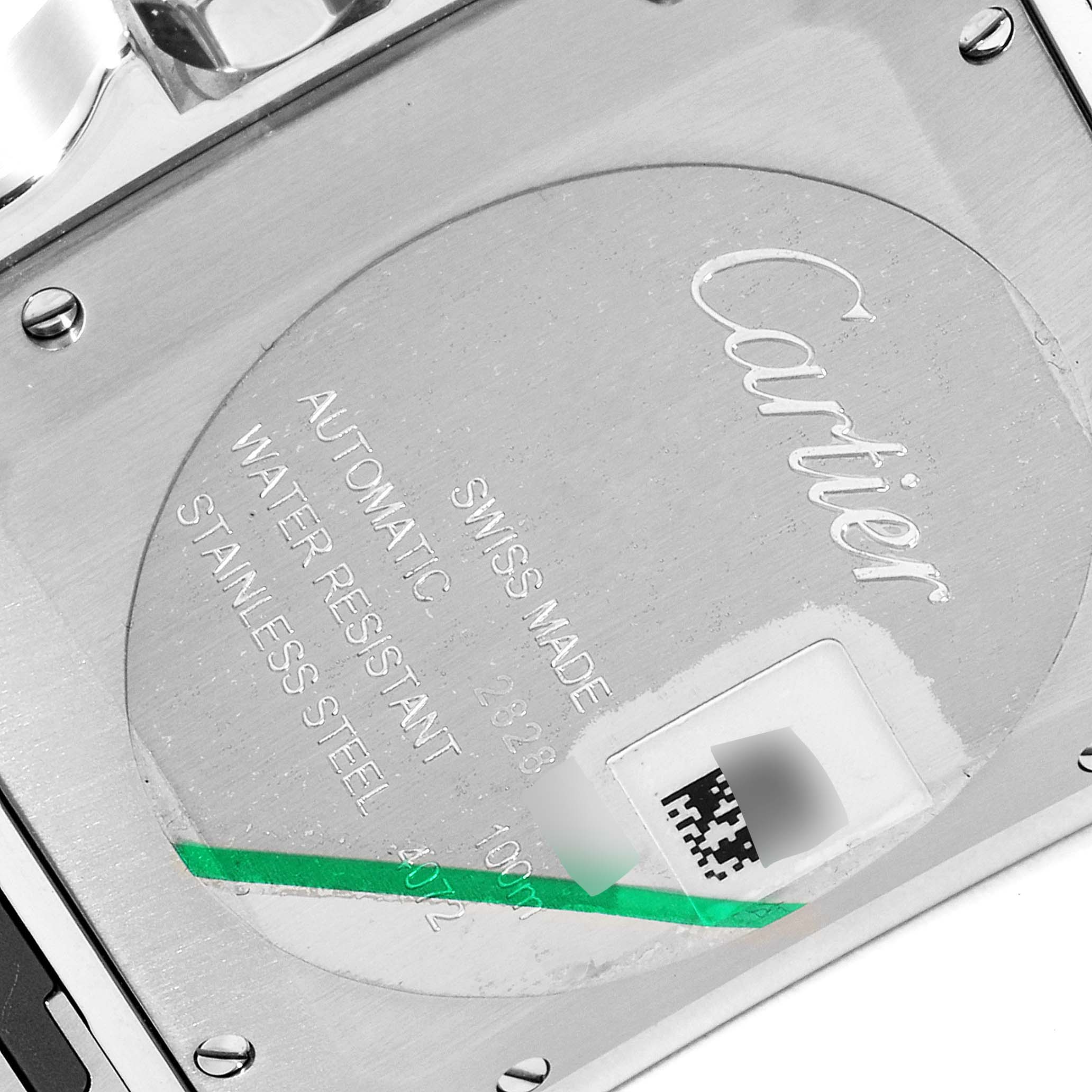 The image shows the back of a Santos model by Cartier, highlighting its engravings and stainless steel case.