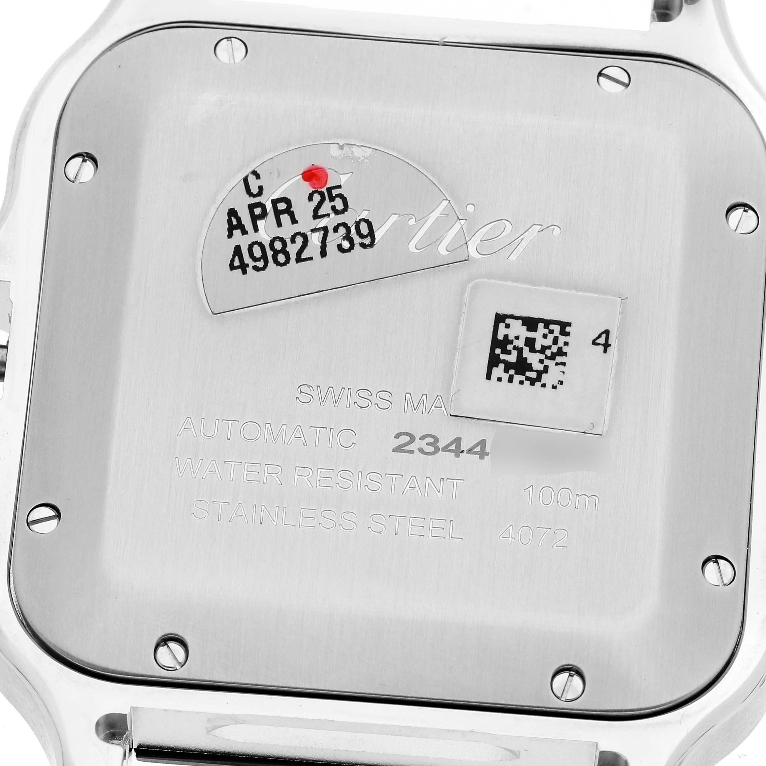 The image shows the case back of a Cartier Santos WSSA0055 Men's Stainless Steel Green Dial WSSA0055 Men's Stainless Steel Green Dial watch, including engravings and a QR code sticker.