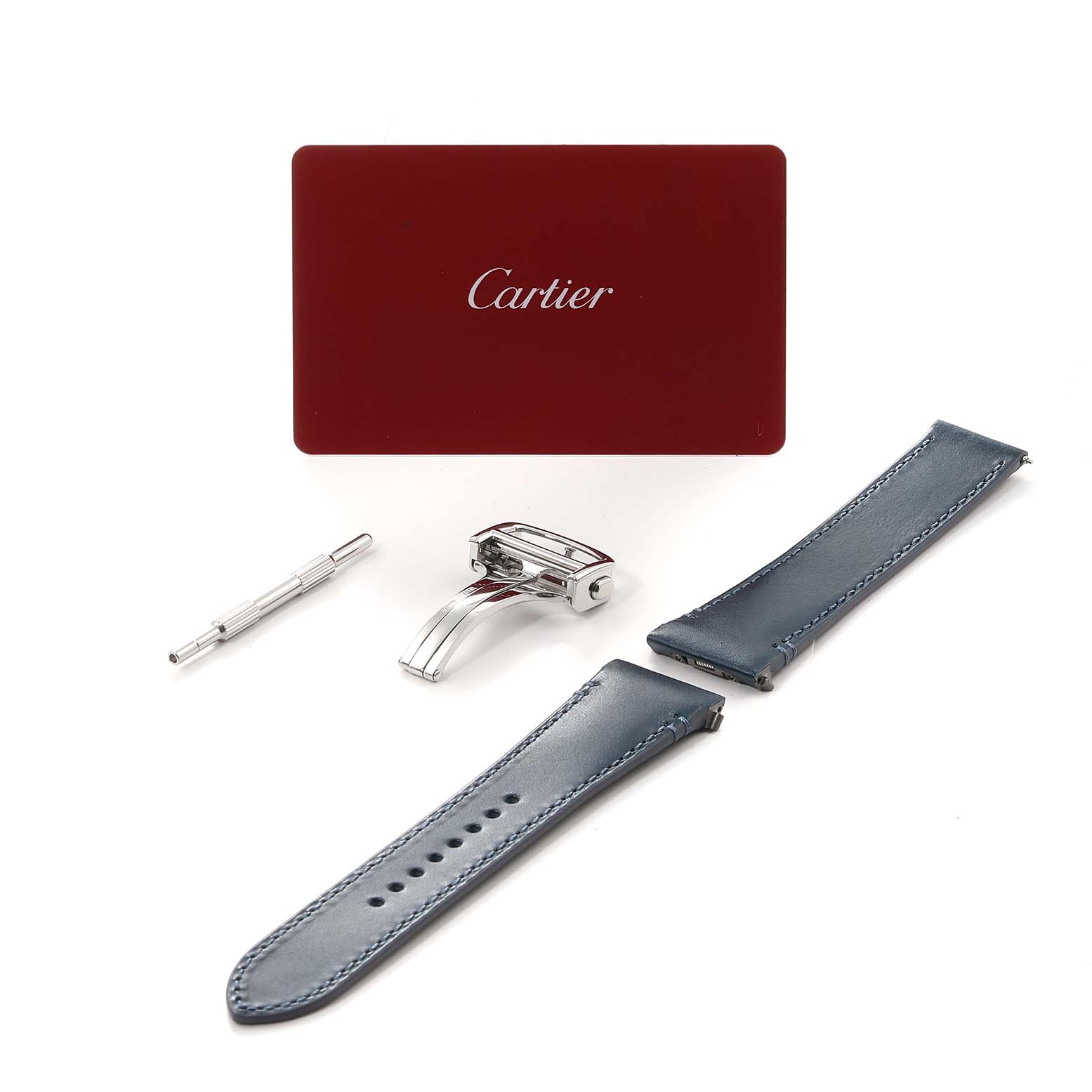 The image shows watch accessories for the Cartier Santos WSSA0030 Men's Stainless Steel Blue Dial WSSA0030 Men's Stainless Steel Blue Dial model, including a tool, clasp, two leather straps, and a Cartier card.