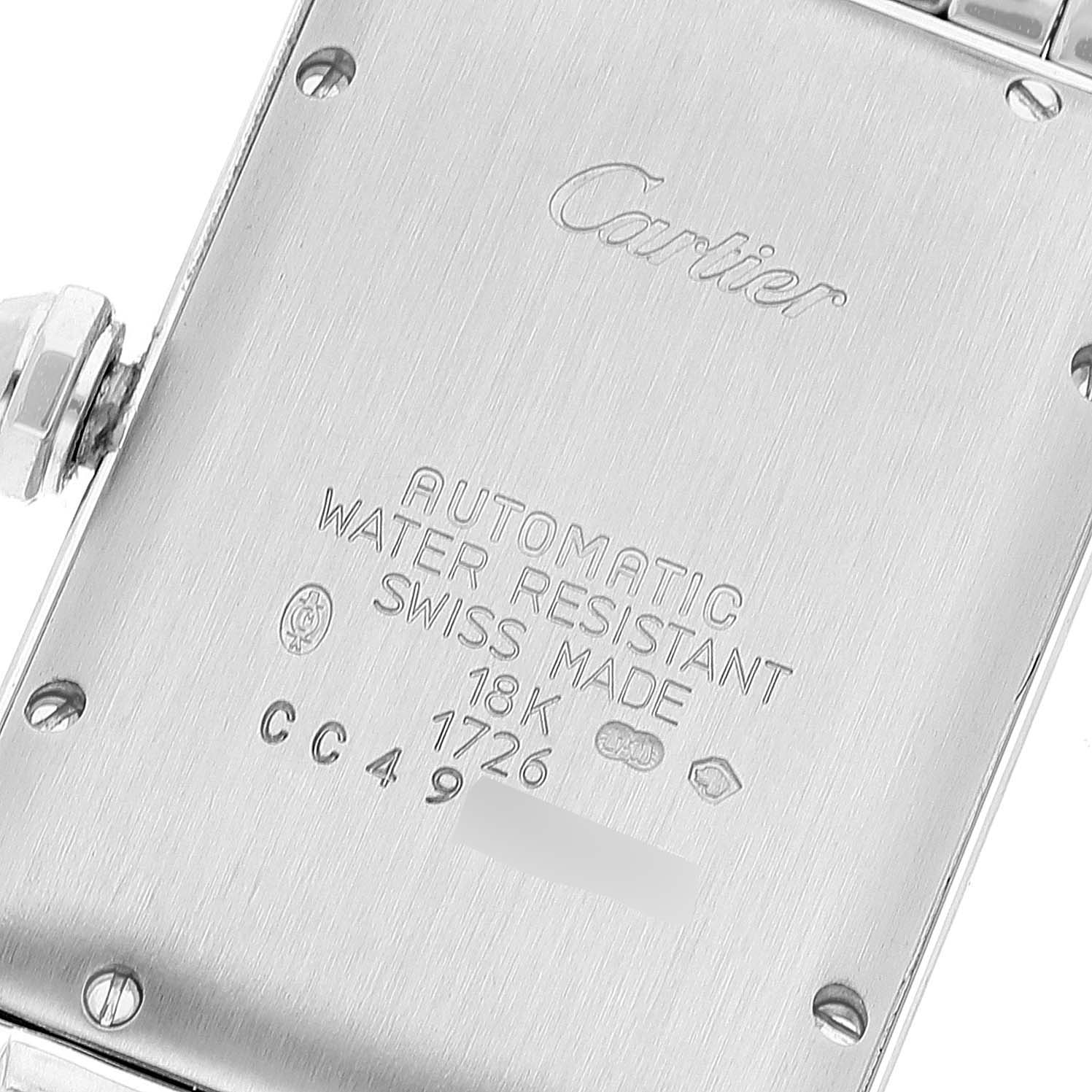 The image shows the case back of the Cartier Tank Américaine watch, highlighting its engravings and markings.