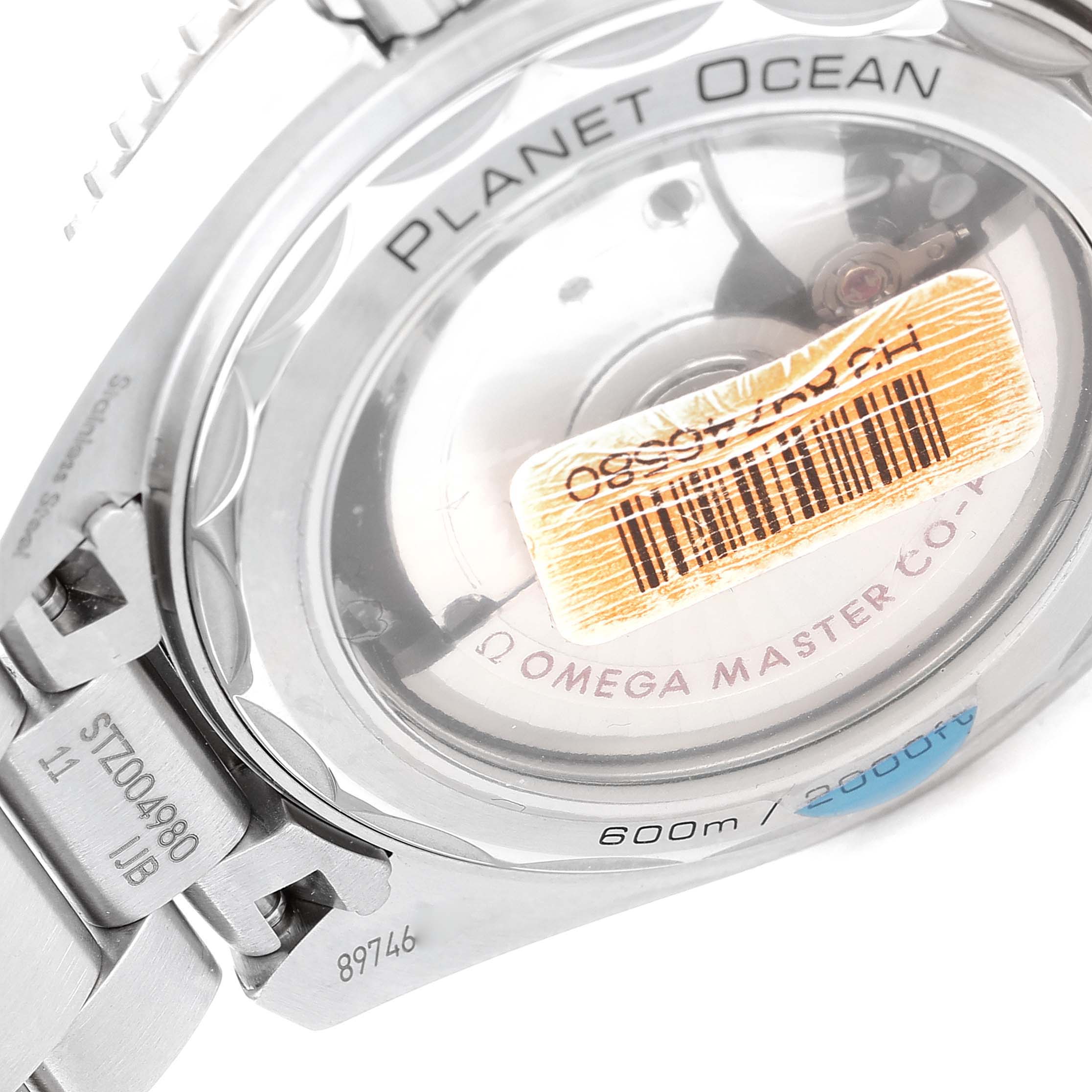 The image shows the back of the Omega Planet Ocean 215.30.40.20.01.001 Men
s Stainless Steel Black Dial 215.30.40.20.01.001 Men
s Stainless Steel Black Dial watch, highlighting its transparent case back and parts of its bracelet.