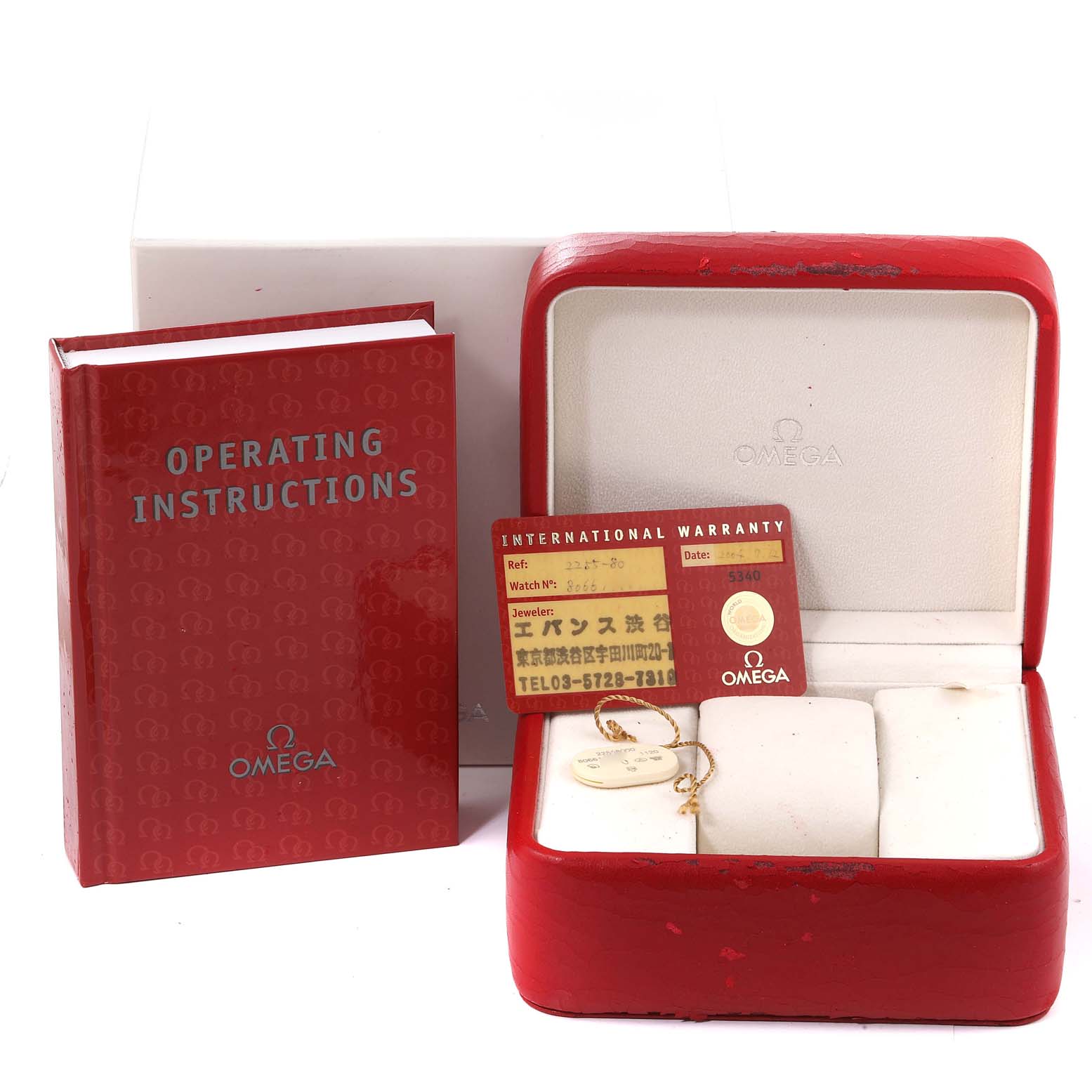 This image shows Omega Seamaster 2255.80.00 Men's Stainless Steel Blue Dial 2255.80.00 Men's Stainless Steel Blue Dial accessories: an operating instructions book, an international warranty card, and an empty watch case.