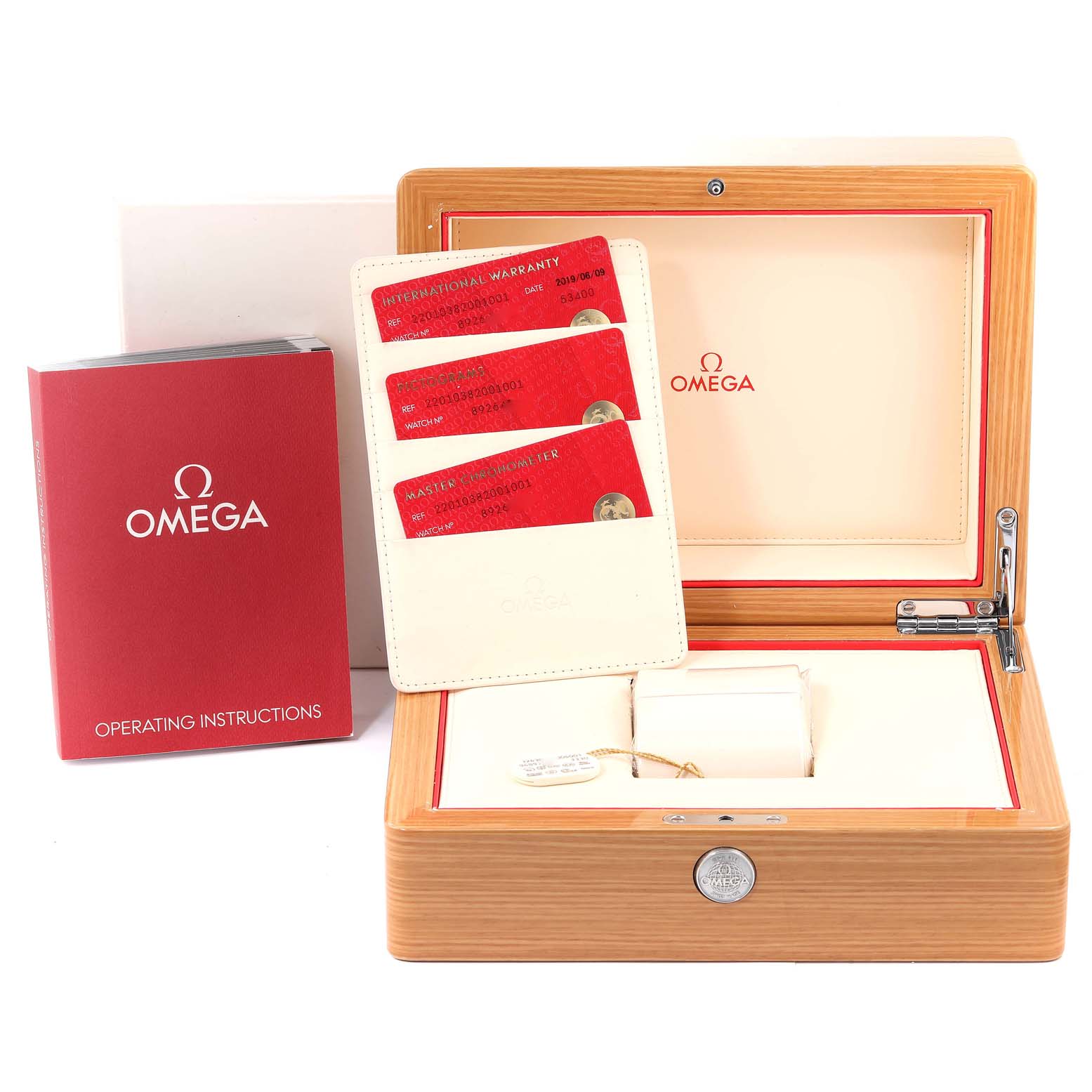 This image shows the Omega Aqua Terra 220.10.38.20.01.001 Men's Stainless Steel Black Dial 220.10.38.20.01.001 Men's Stainless Steel Black Dial watch's wooden box, booklet, and red warranty cards.